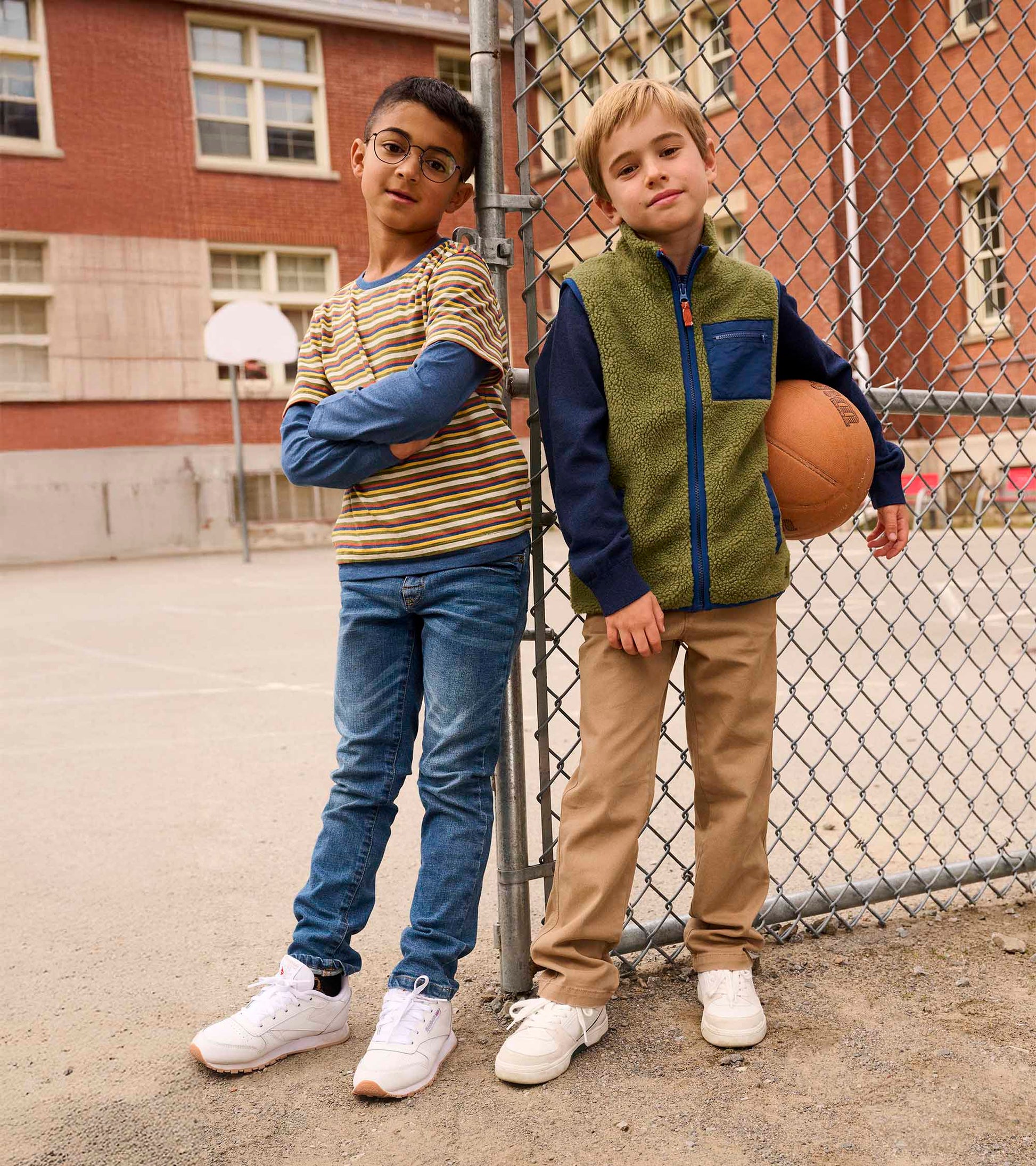 Loden green faux sherpa vest with navy accents, worn by a boy holding a basketball, paired with casual pants and sneakers.