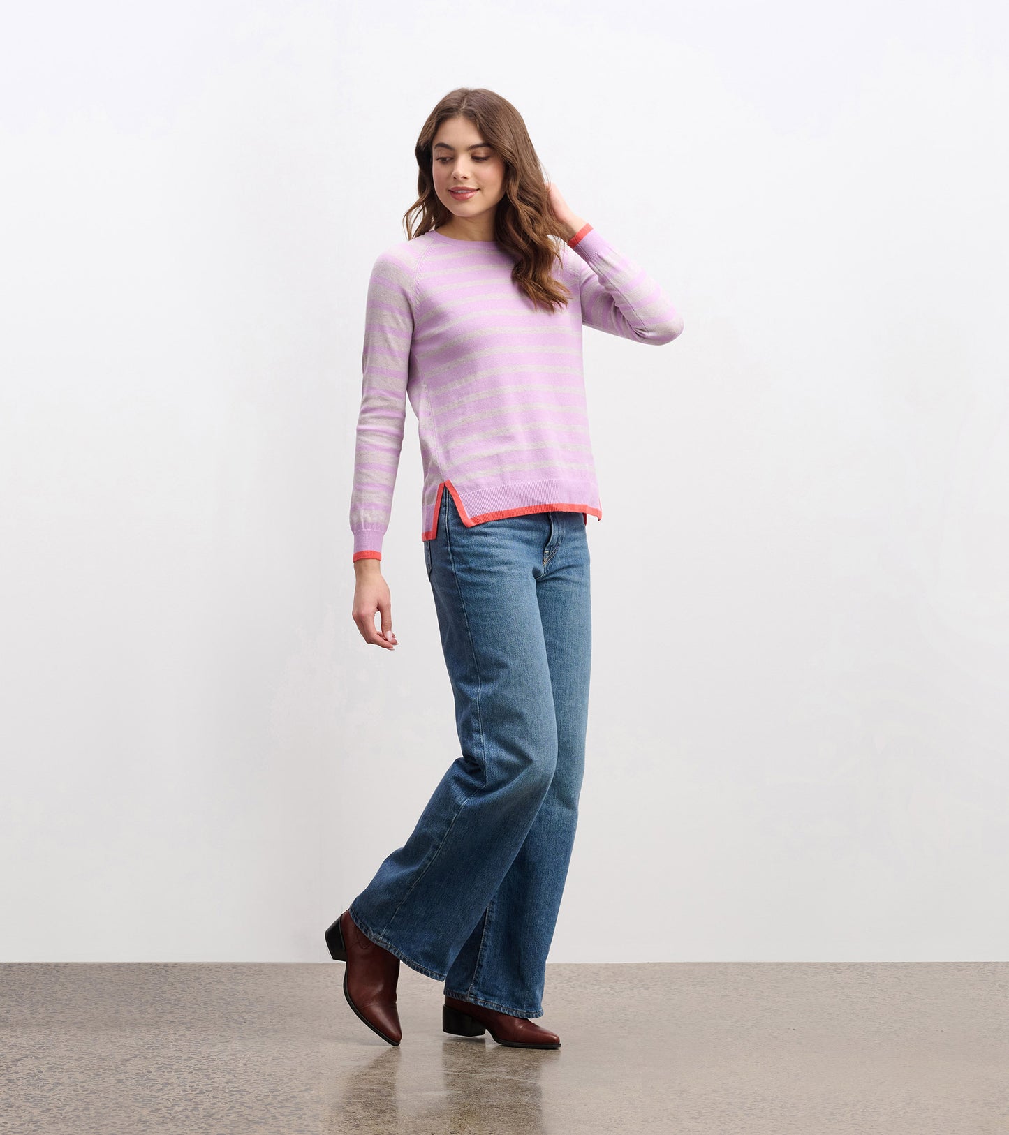 Lilac pink striped long-sleeve sweater with coral trim, worn with jeans; front view