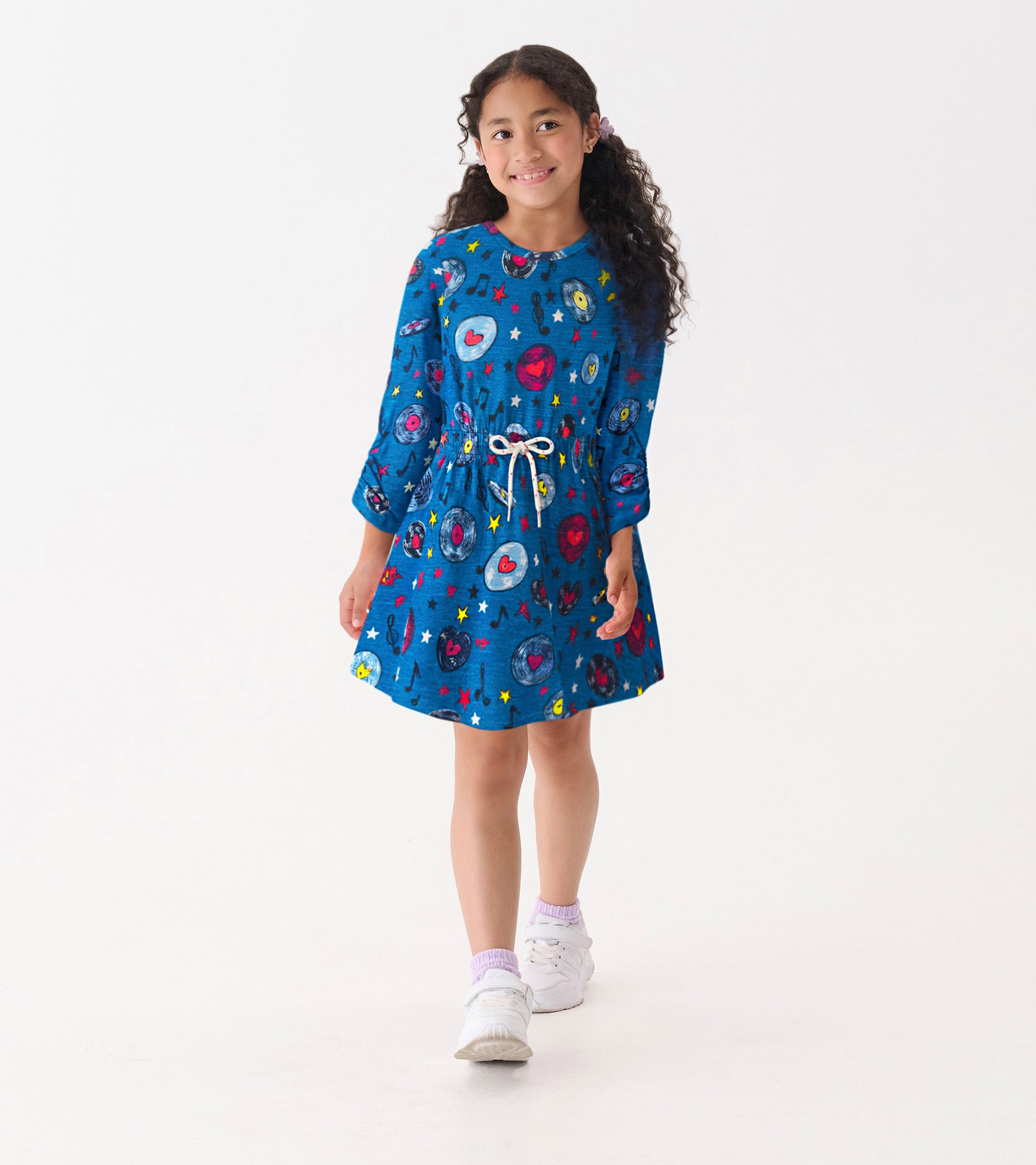 Blue cinched waist dress featuring colorful music-themed patterns, long sleeves, and a drawstring waist.