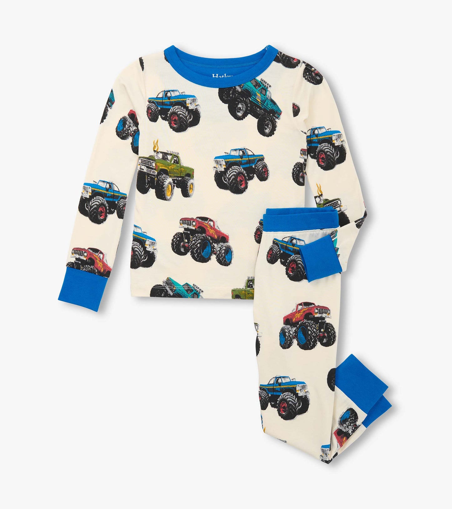 Boys' pajama set featuring a cream background with colorful monster truck prints and blue accents on the cuffs and neckline.