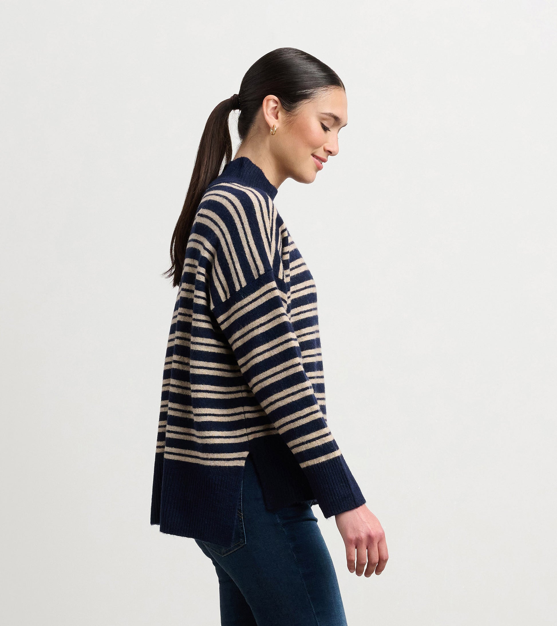 Navy and camel striped mock neck sweater with side slits, featuring a relaxed fit and long sleeves.