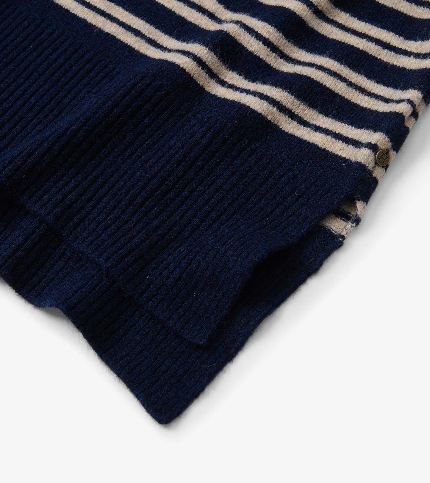 Navy and cream striped knit sweater with ribbed hem and a small side logo tag, folded view