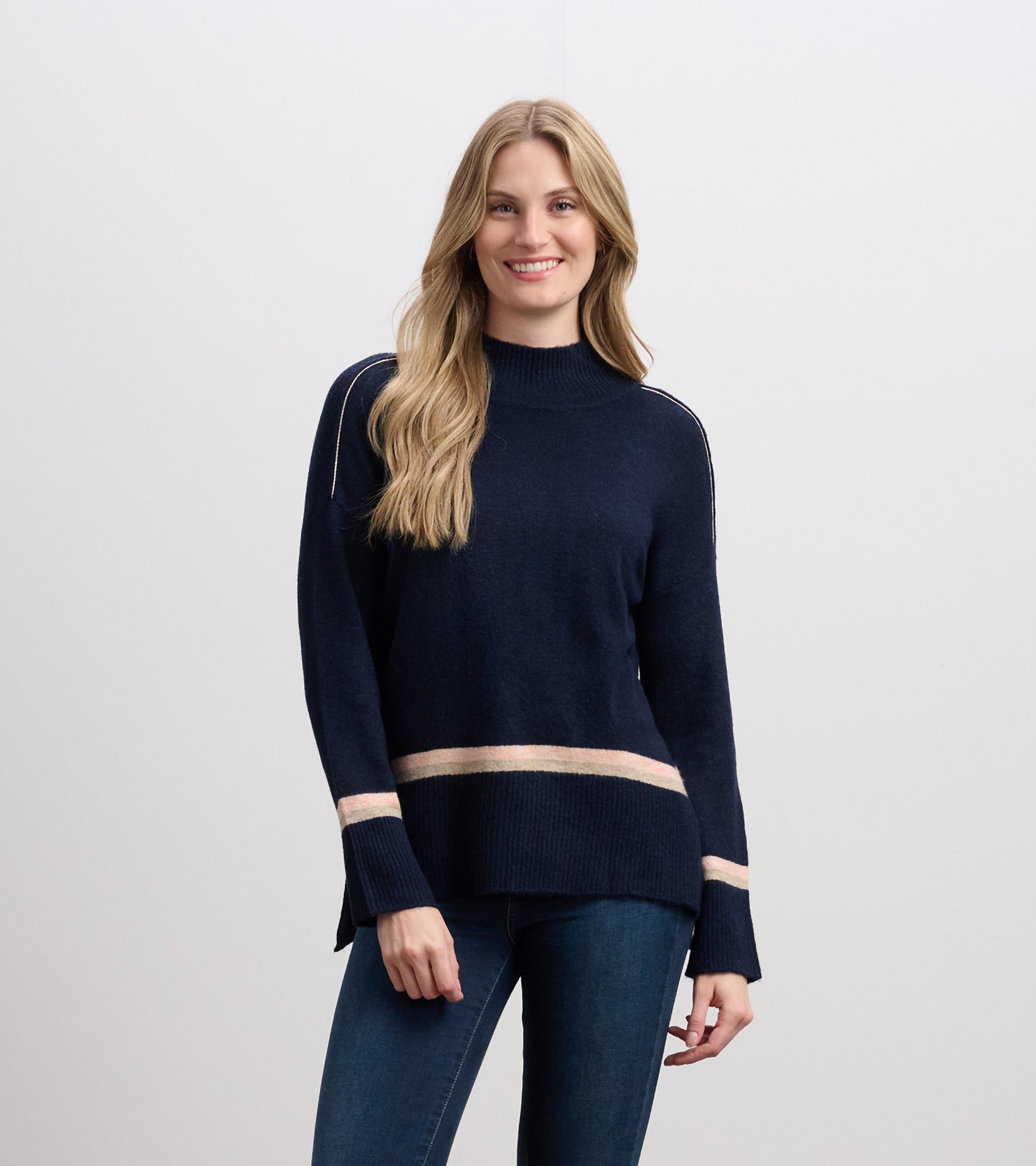 Navy mock neck sweater with light pink stripes at the hem and sleeves, featuring a relaxed fit and long sleeves.