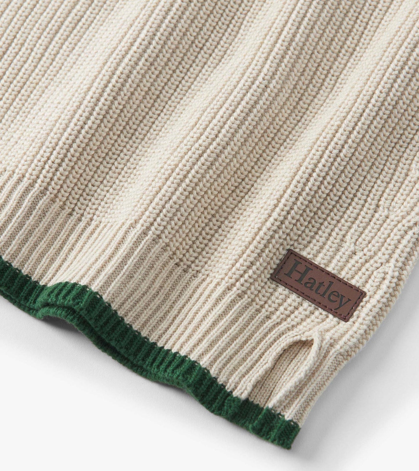 Oatmeal melange sweater with ribbed texture and green hem, featuring a button neck and side slit detail.