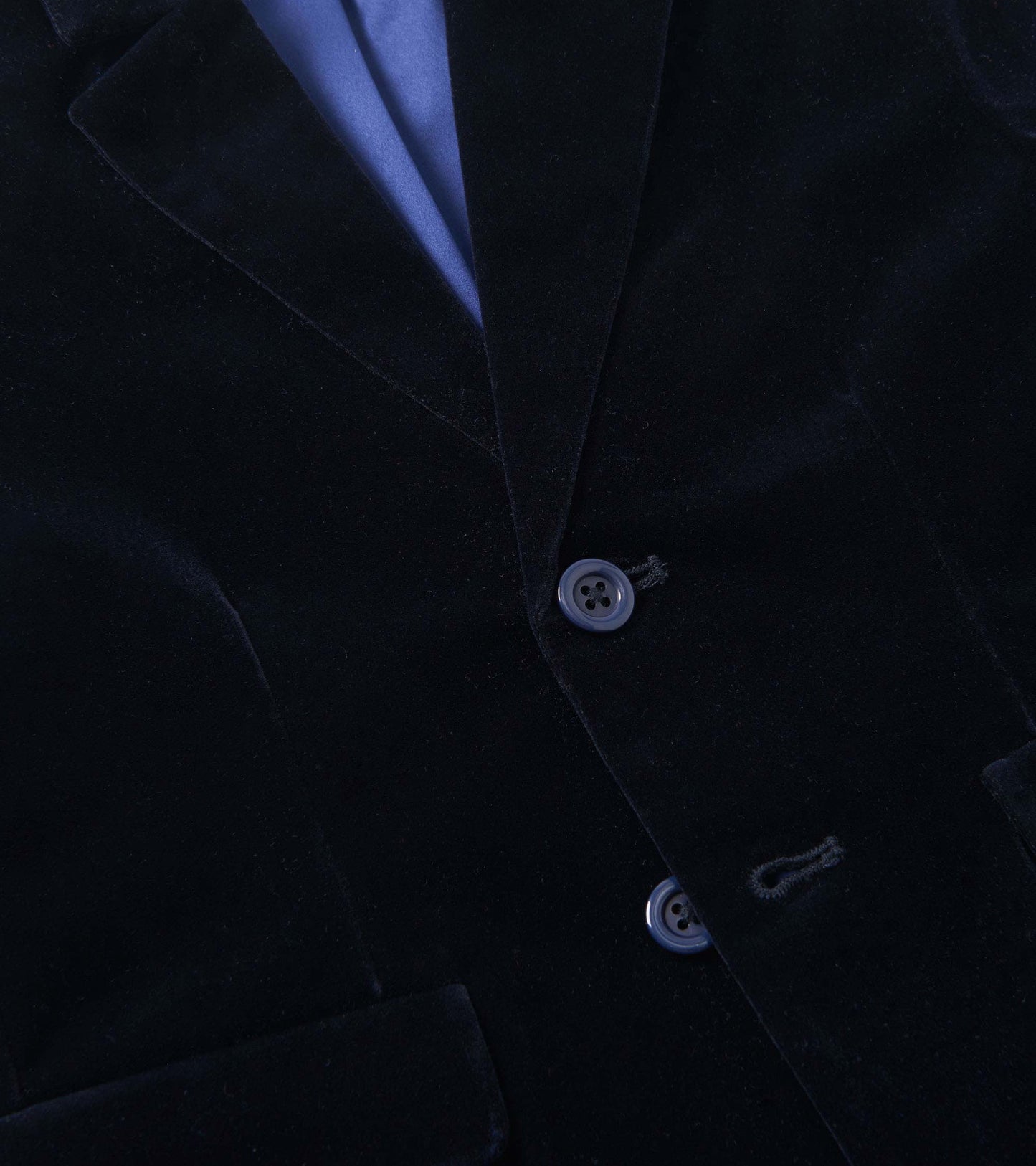 Navy velveteen blazer with a smooth texture, featuring two buttons and a notched collar.