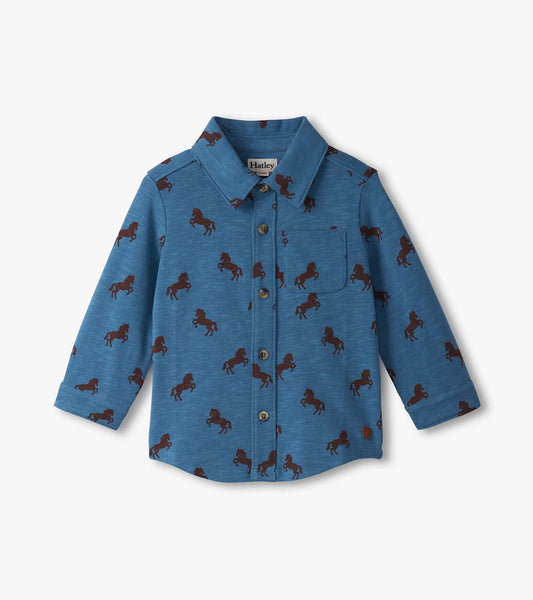 Blue button-down shirt for baby and toddler boys featuring a playful brown horse pattern. Long sleeves and chest pocket.