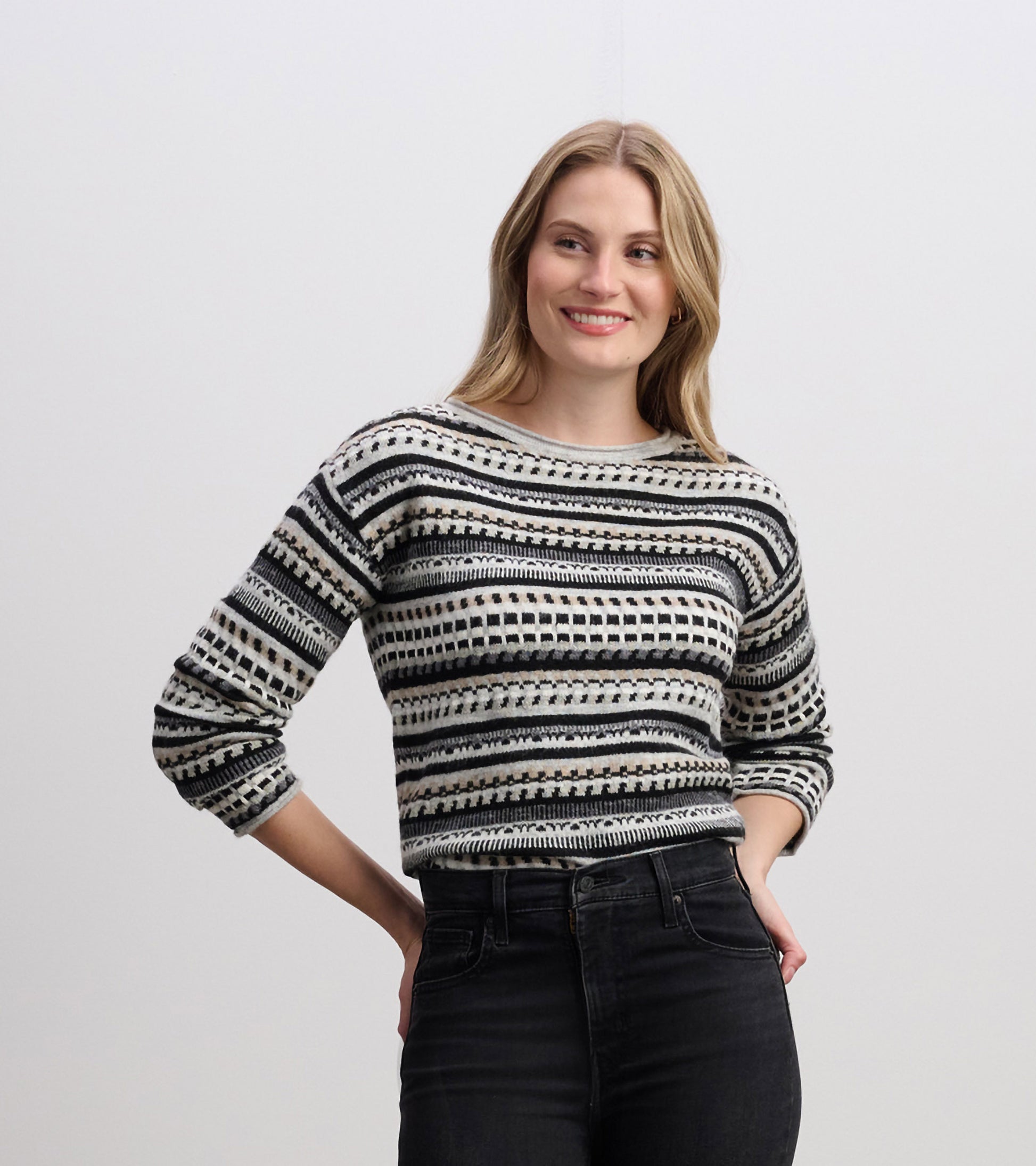 Stone grey sweater with black and white striped pattern, featuring a round neckline and three-quarter sleeves.