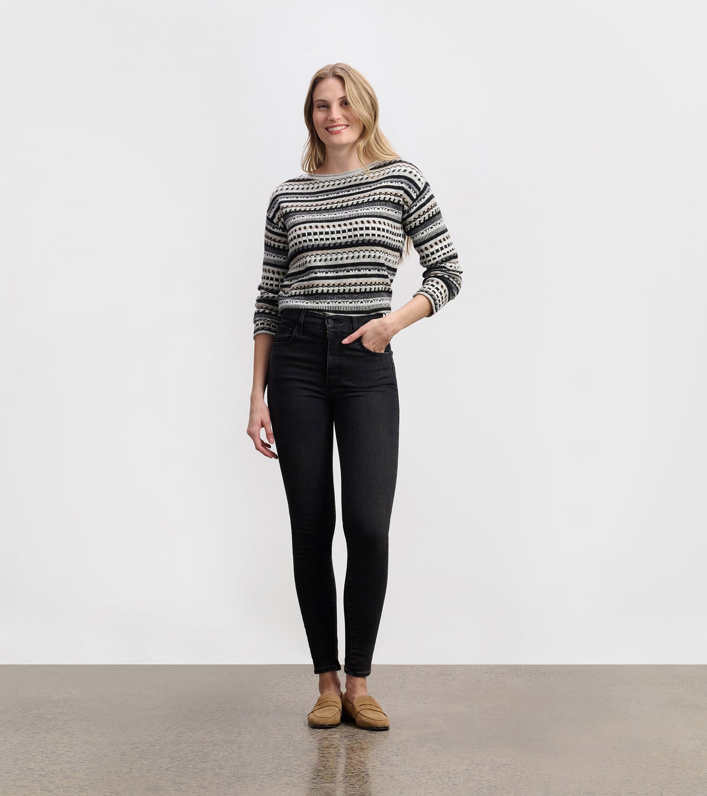 Stone grey patterned knit sweater with black and white stripes, long sleeves, shown on a model front view.
