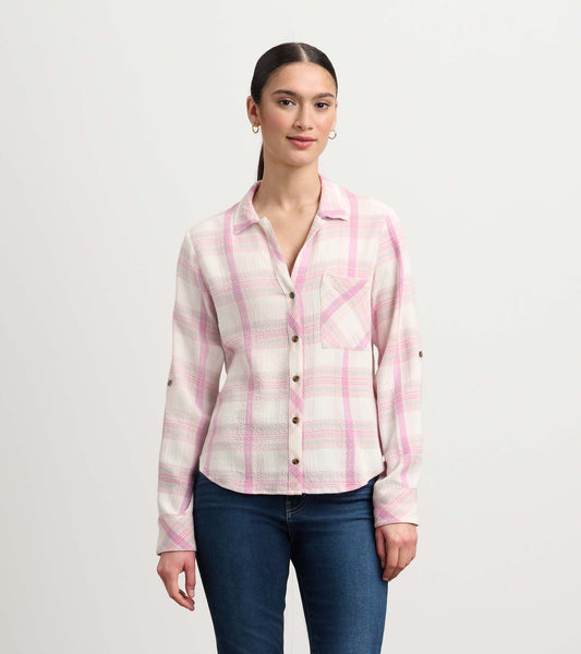 Pink plaid button-down shirt with a chest pocket, long sleeves, and a relaxed fit. Worn with blue jeans.
