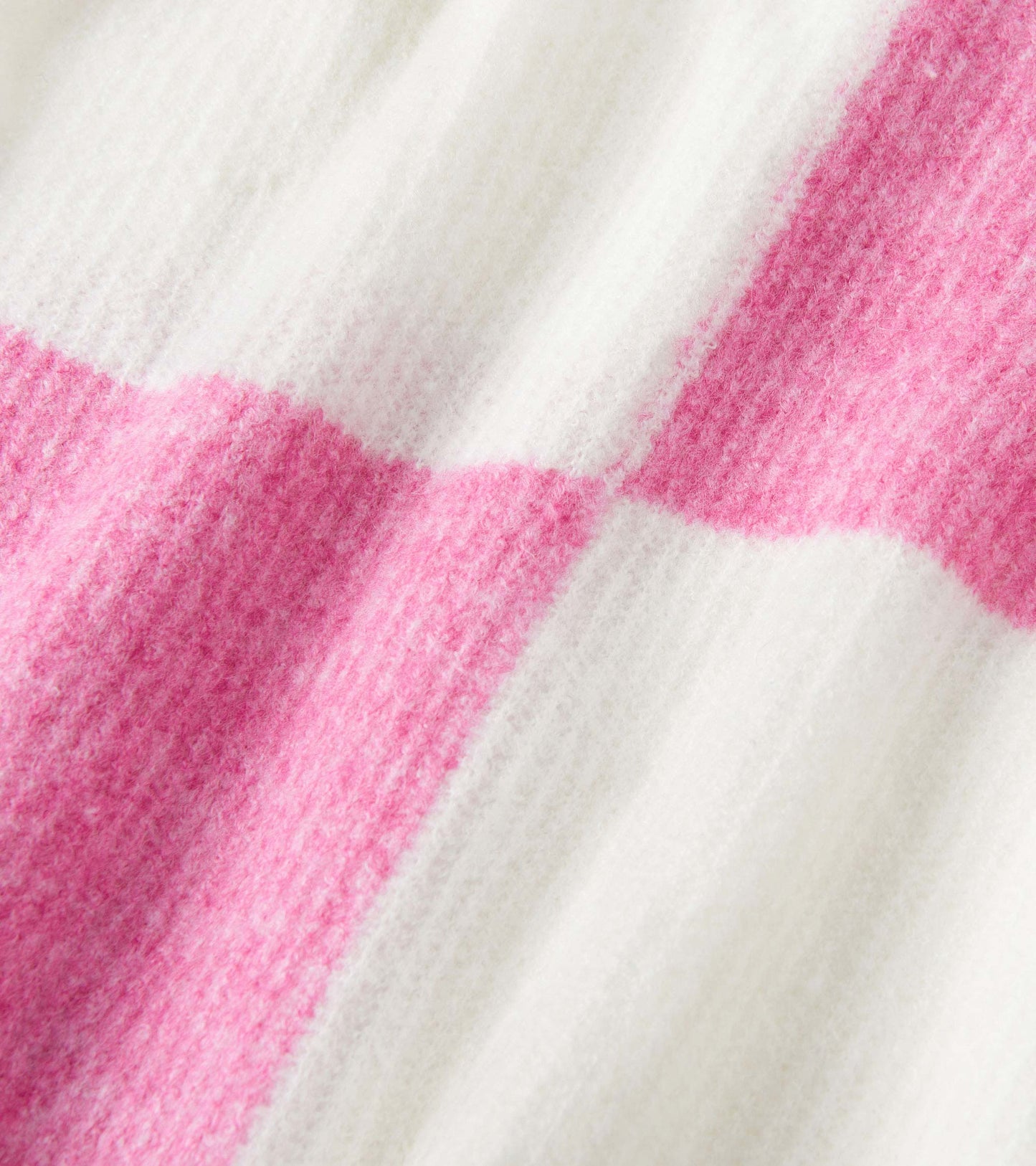 Pink and white check pattern drop shoulder sweater with a soft, textured fabric.