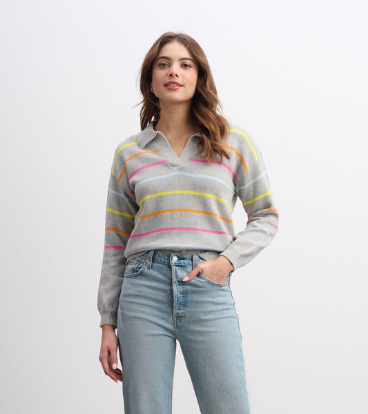 Gray sweater with colorful stripes, featuring a v-neck and long sleeves, paired with light blue jeans.