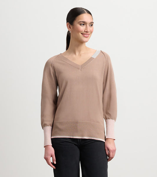 Camel-colored sweater with a V-neck, long sleeves, and striped cuffs, styled for a relaxed fit.