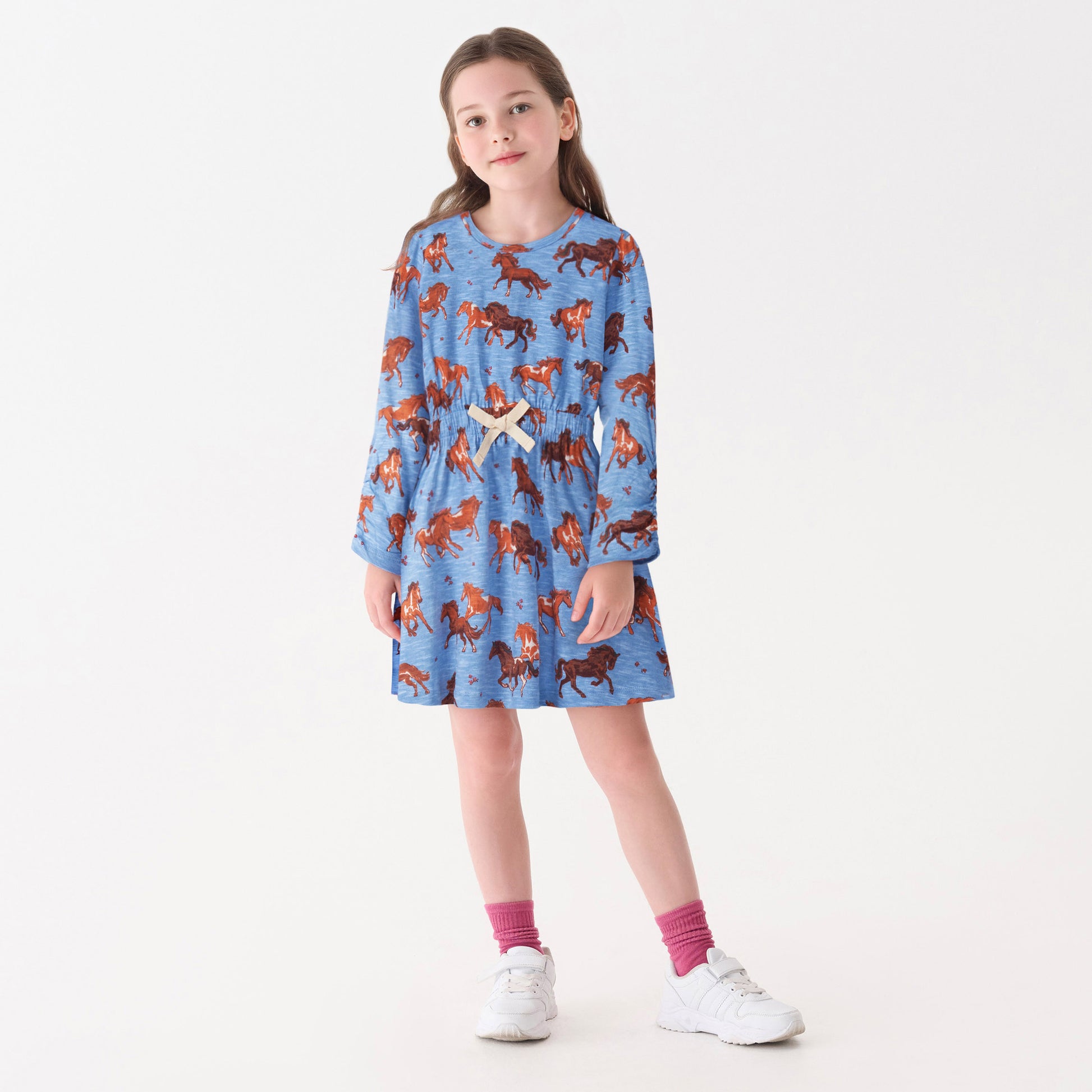 Blue dress with horse print, cinched waist, long sleeves, and a round neckline, suitable for casual wear.