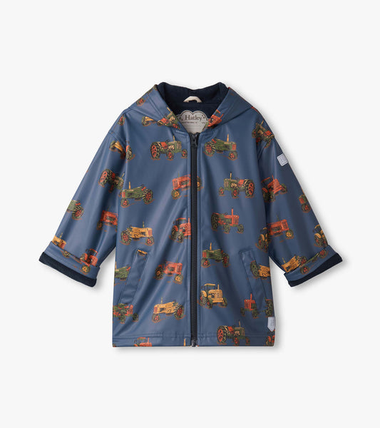 Blue zip-up rain jacket featuring colorful tractor patterns, designed for boys with a hood and front pockets.