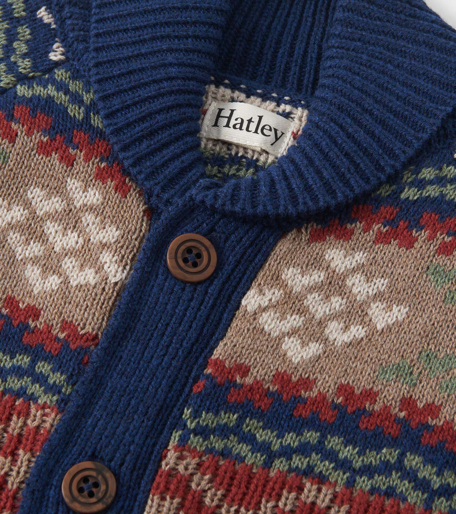 Boys' vintage cardigan featuring a shawl collar, Fair Isle pattern in navy, red, green, and beige with brown buttons.