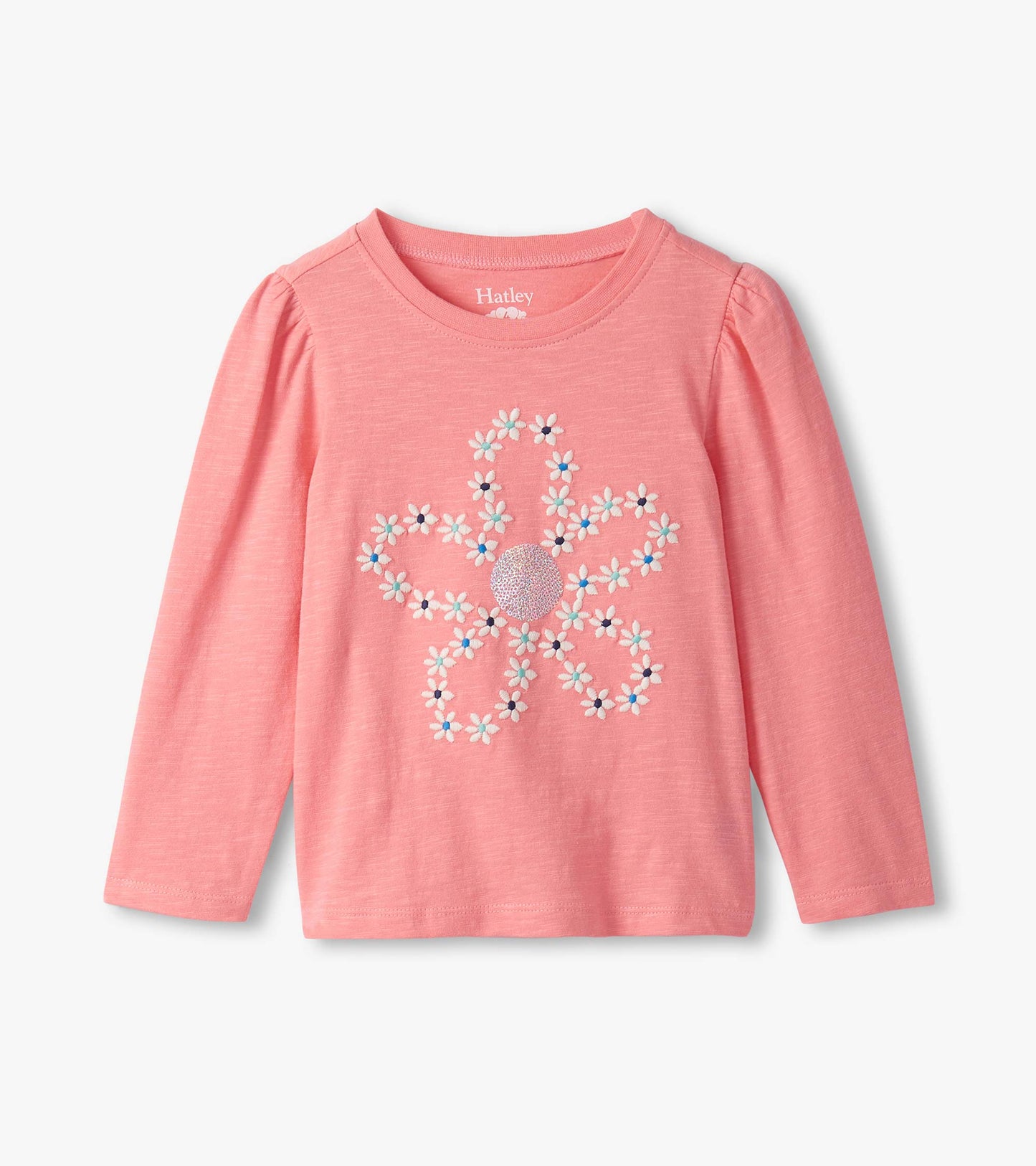 Pink long-sleeve tee featuring embroidered flower design with colorful accents and puff sleeves.