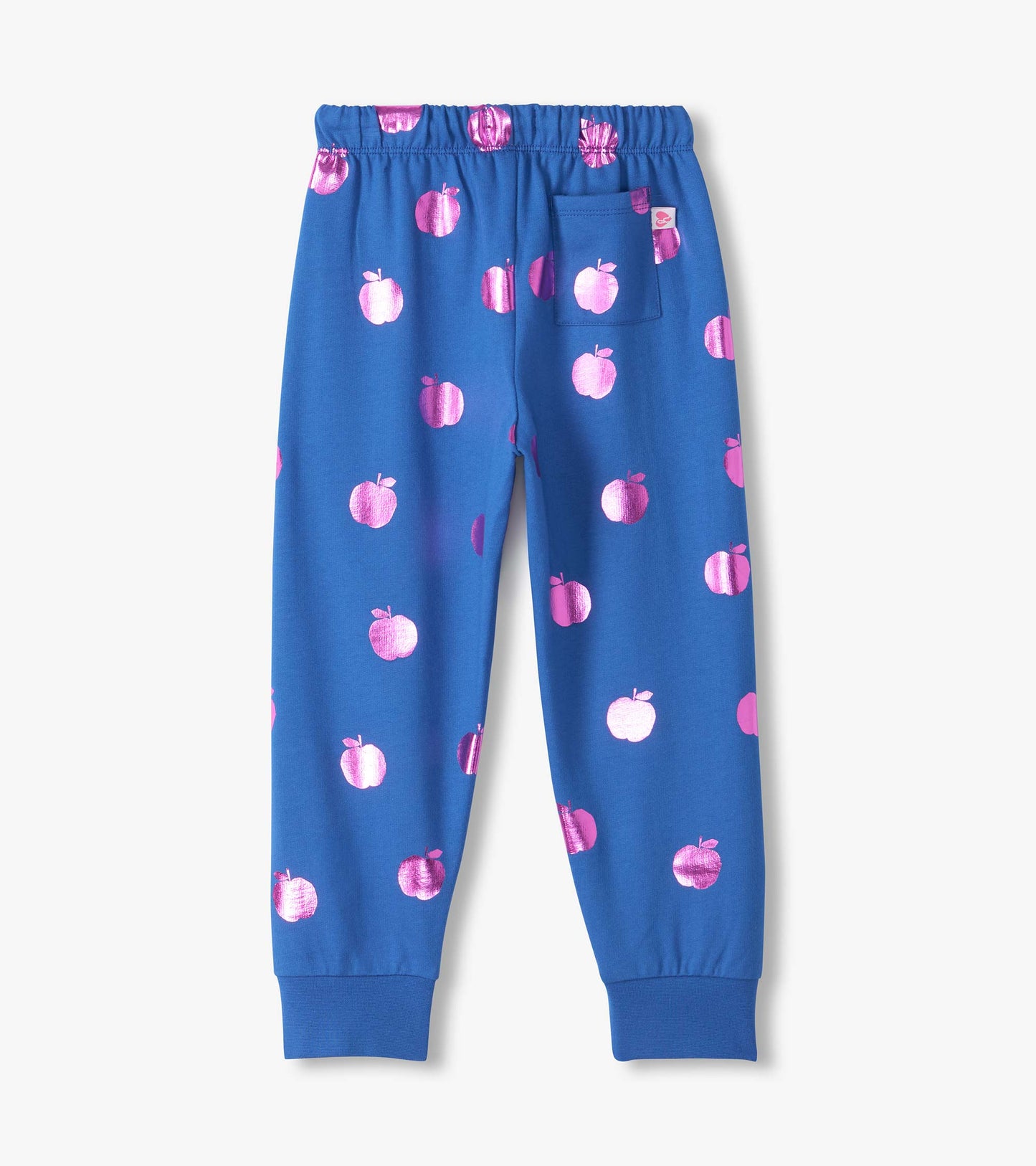 Back view of blue track pants with metallic pink apple print, elastic waist, back pocket, and cuffed ankles