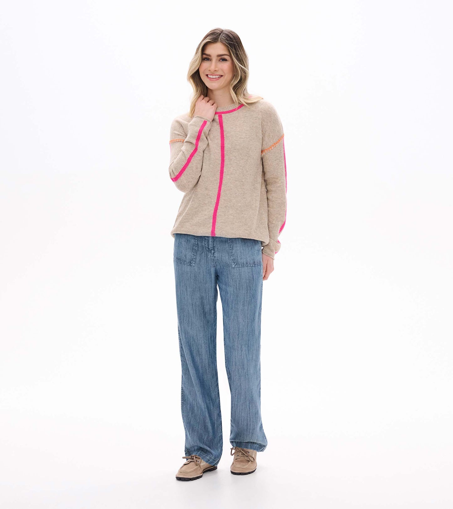 Front view of oatmeal sweater with neon pink trim, center seam, and long sleeves