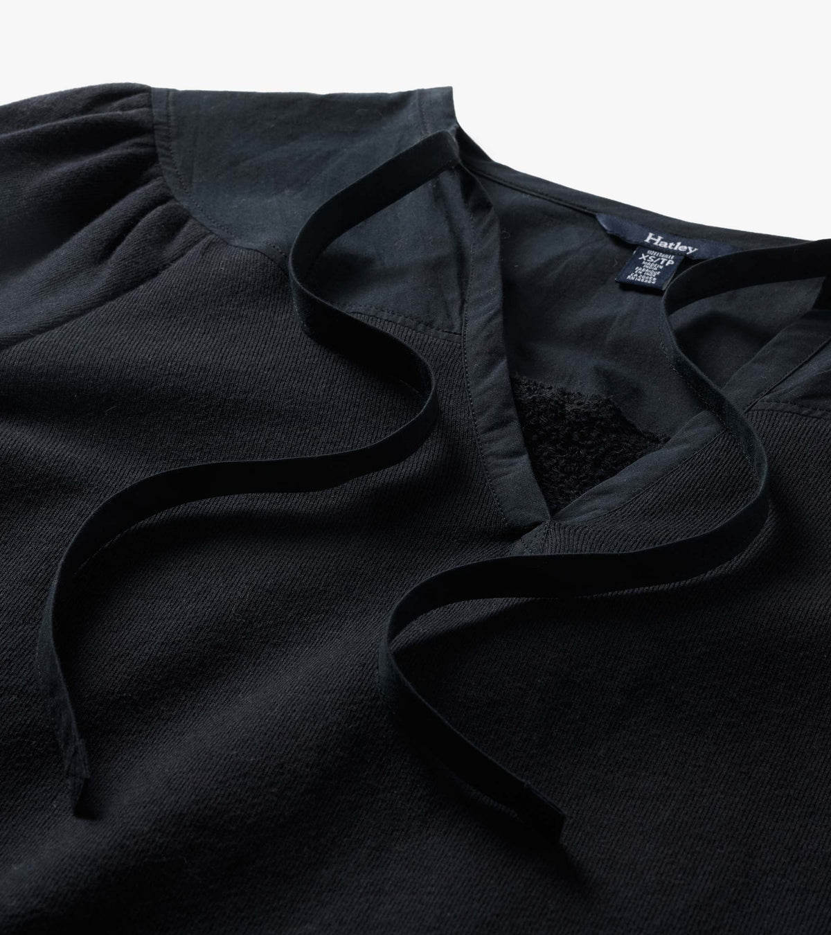 Black Mix Match Top close-up with gathered shoulder, V-neck opening, and long tie details