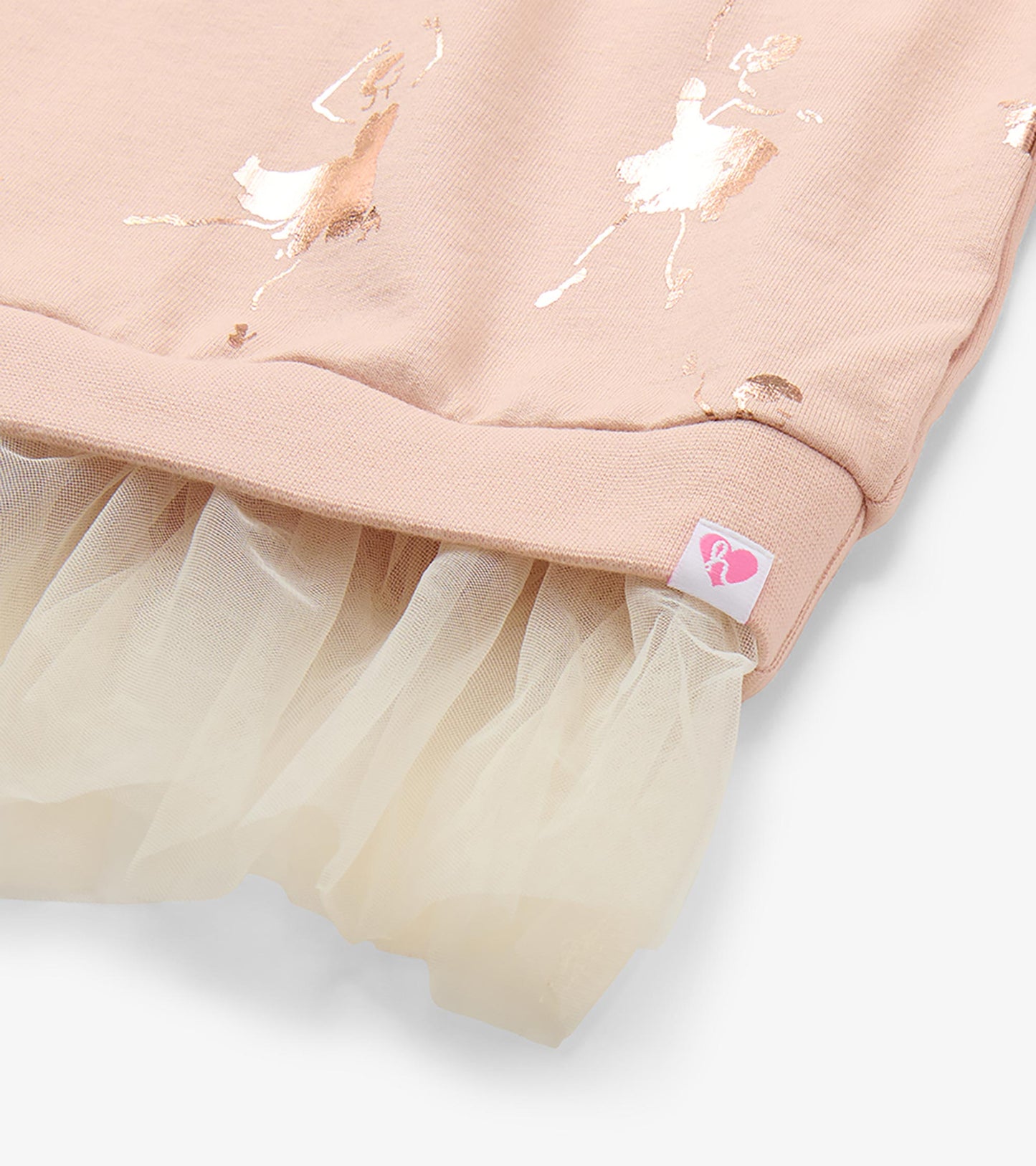 Close-up of blush ribbed hem with cream tulle underlay and rose gold ballerina print detail