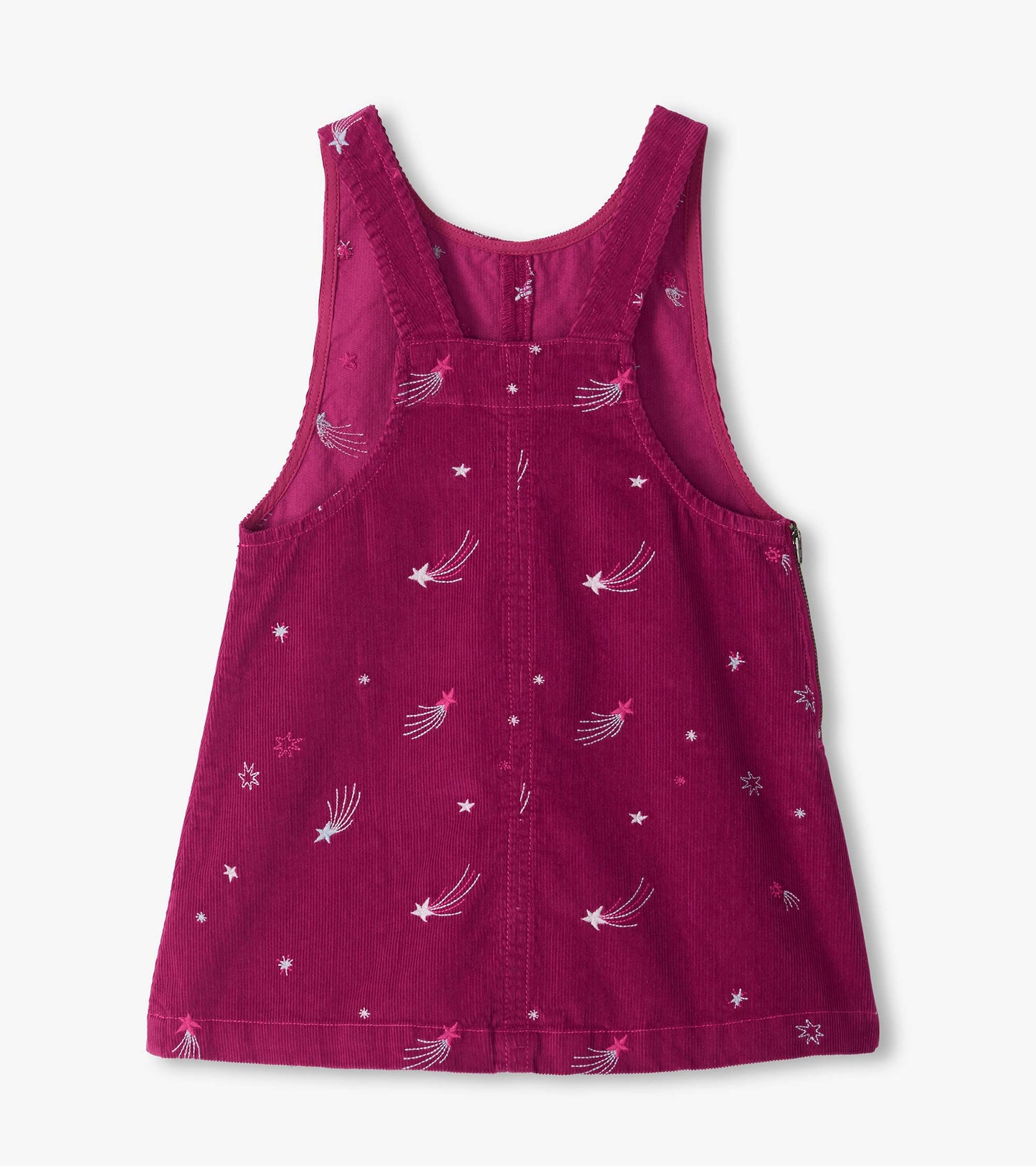 Back view of magenta pinafore dress with crossed straps and embroidered stars and shooting stars