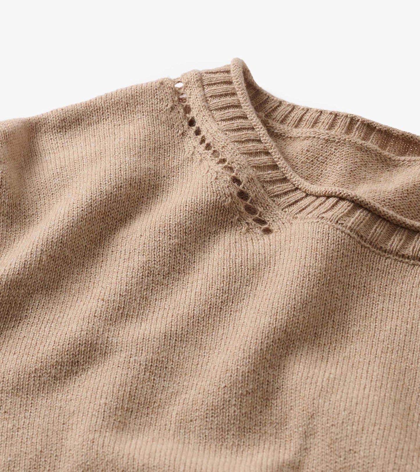Close-up of oatmeal melange crew neck sweater with ribbed collar and open-knit detail at the shoulder
