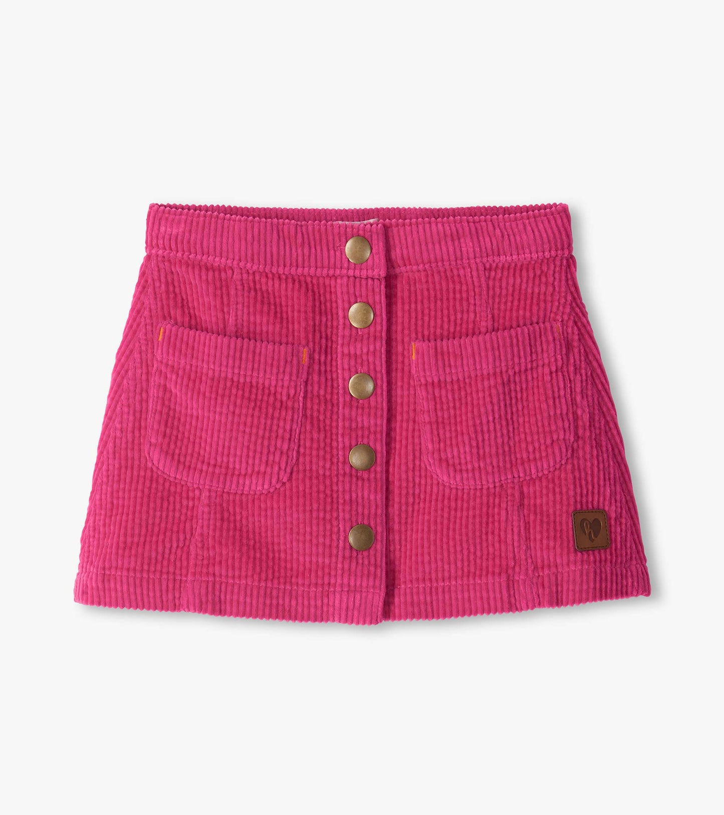 Pink A-line corduroy skirt with front snap buttons, two front pockets, and a small logo patch near the hem