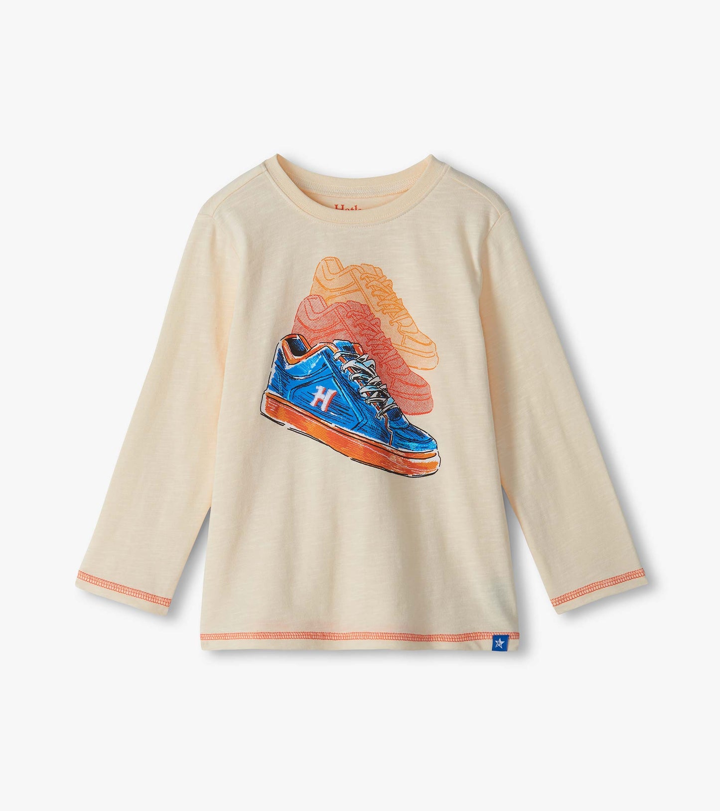 Cream long sleeve crew neck tee with colorful sneaker graphic on the front