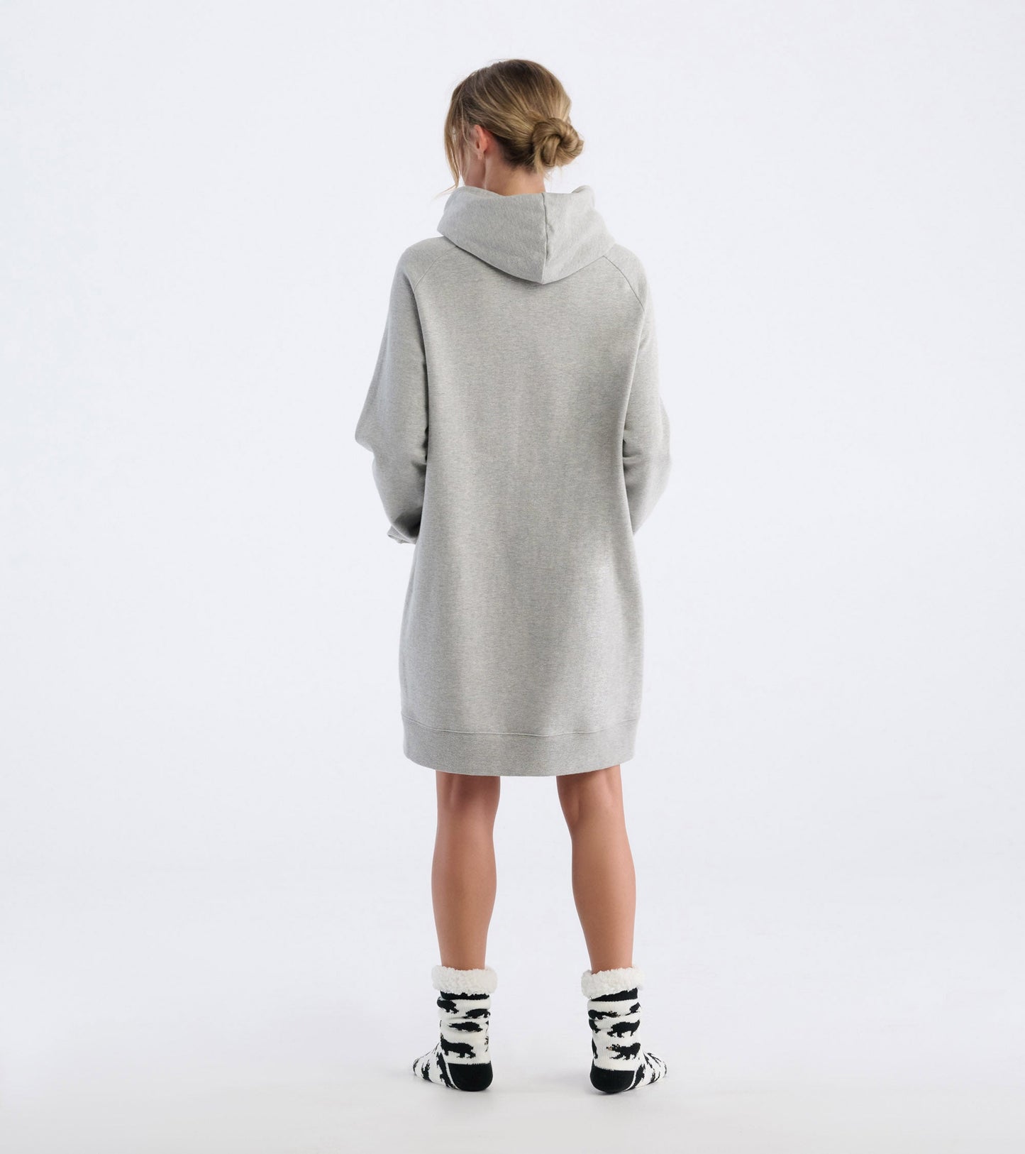 Oversized black hoodie with a cozy fit, featuring a hood and long sleeves, styled with patterned socks.