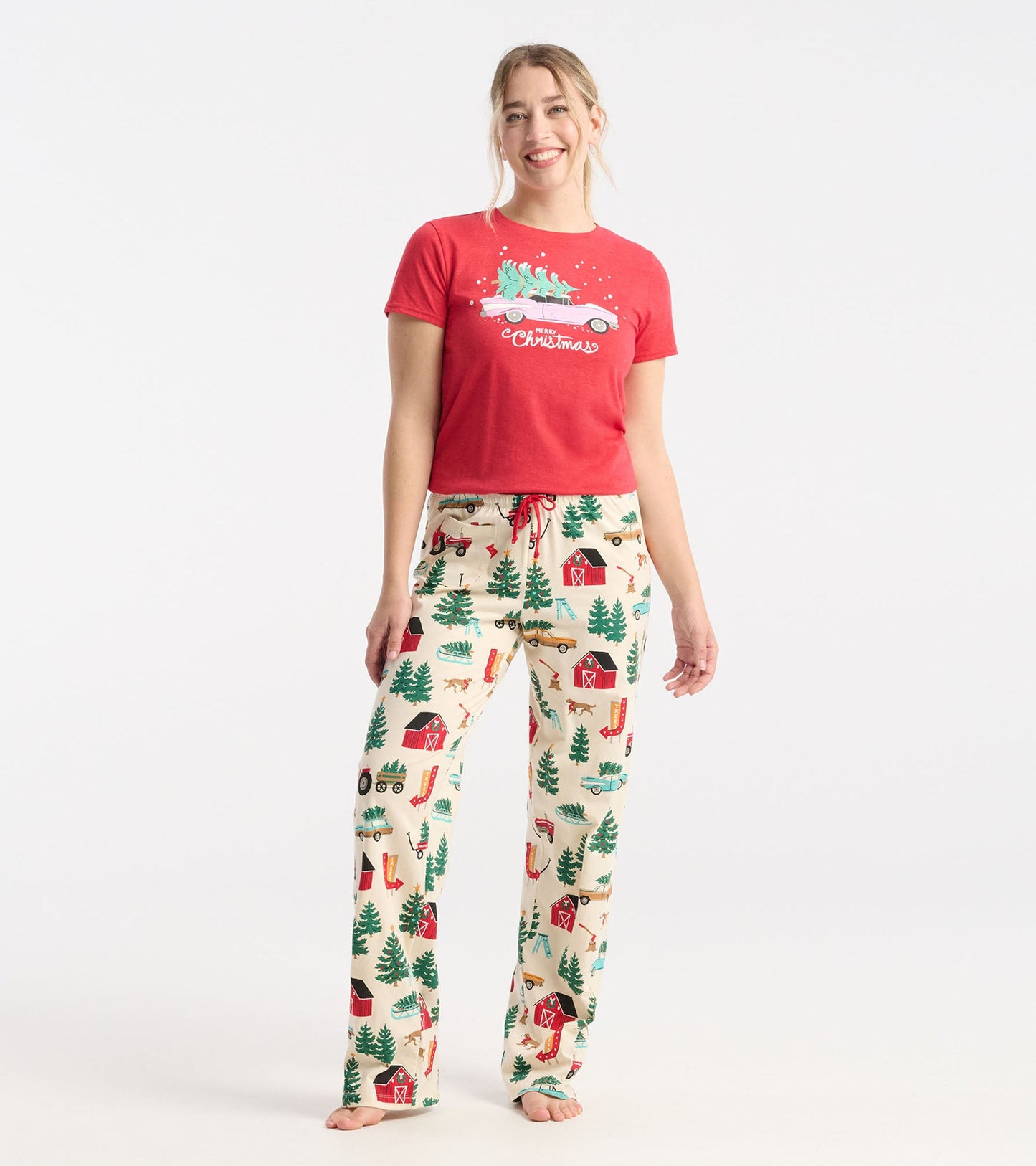 Cream cotton pajama pants featuring a festive Christmas tree farm print with red drawstring and relaxed fit.