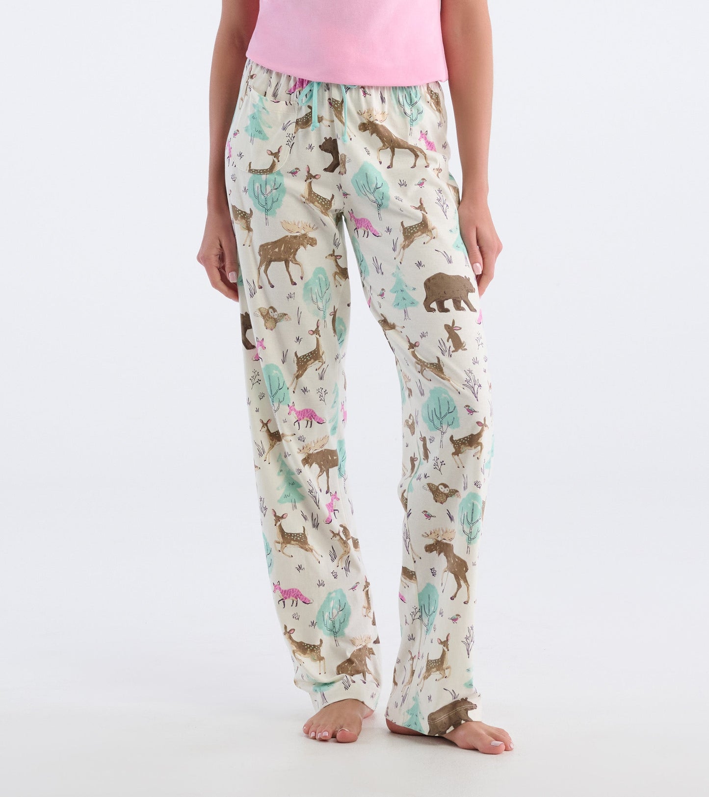 Light cream cotton pajama pants featuring a playful forest animal print in brown, green, and pink tones.