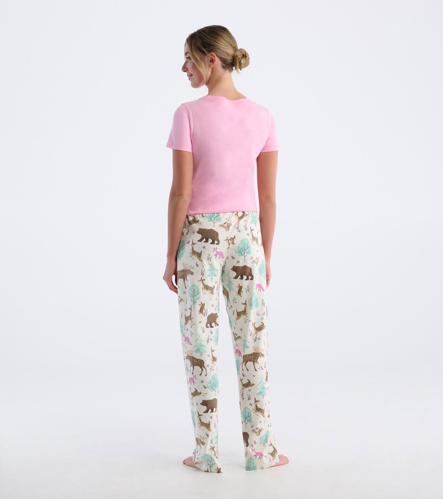 Cotton pajama pants featuring a playful forest animal print in soft pastel colors, shown from the back.