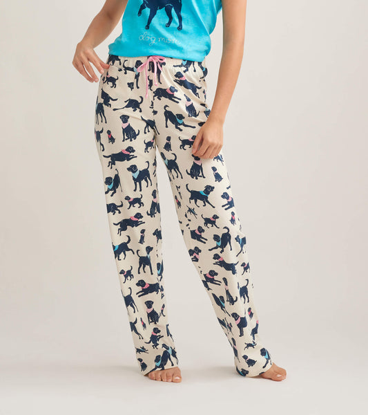Women's cotton pajama pants featuring a playful dog print on a cream background, with a pink drawstring waist.