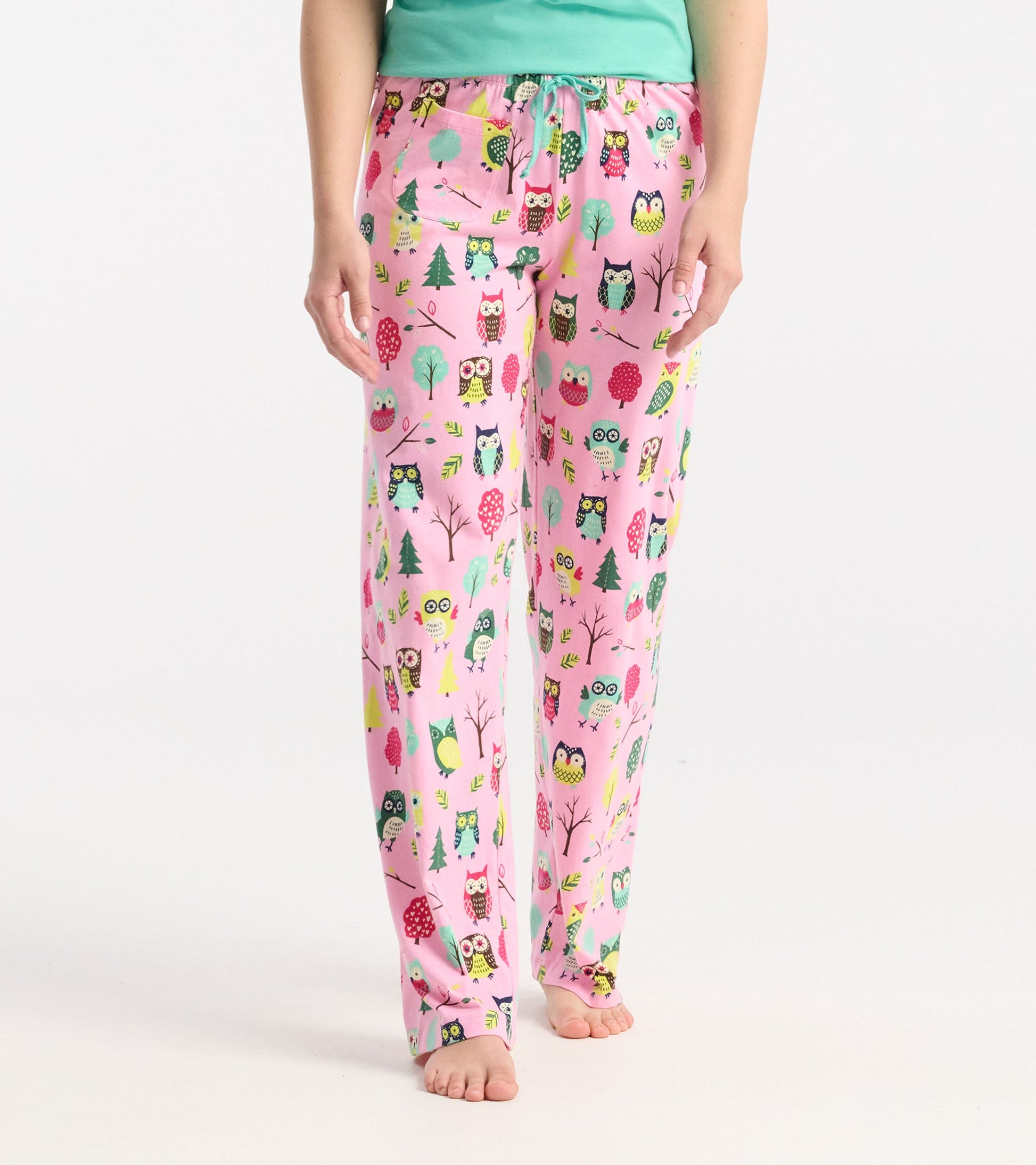 Pink cotton pajama pants featuring a colorful owl and tree pattern, with an elastic waistband and drawstring.