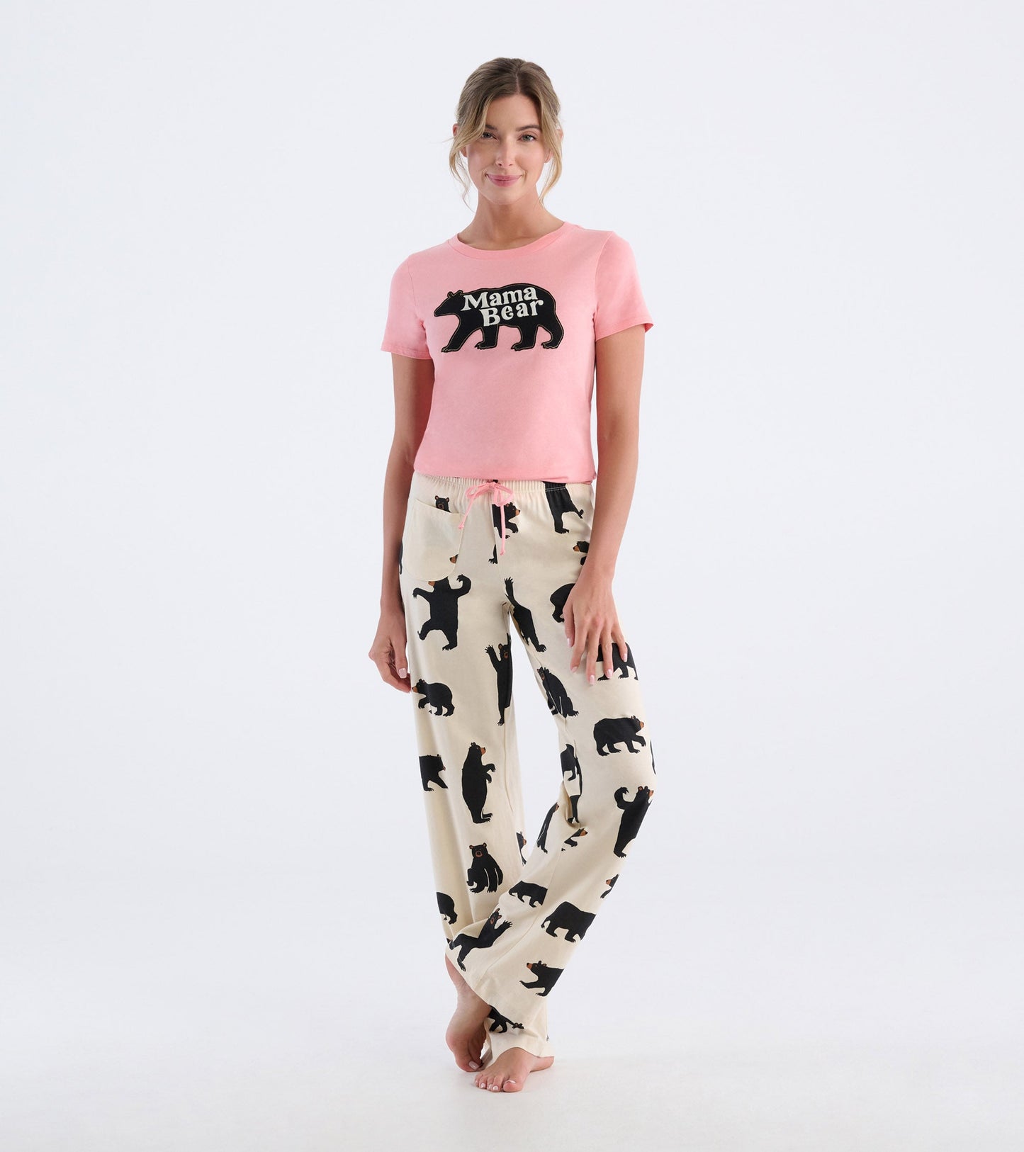 Light pink t-shirt with "Mama Bear" graphic paired with cream pajama pants featuring black bear silhouettes.
