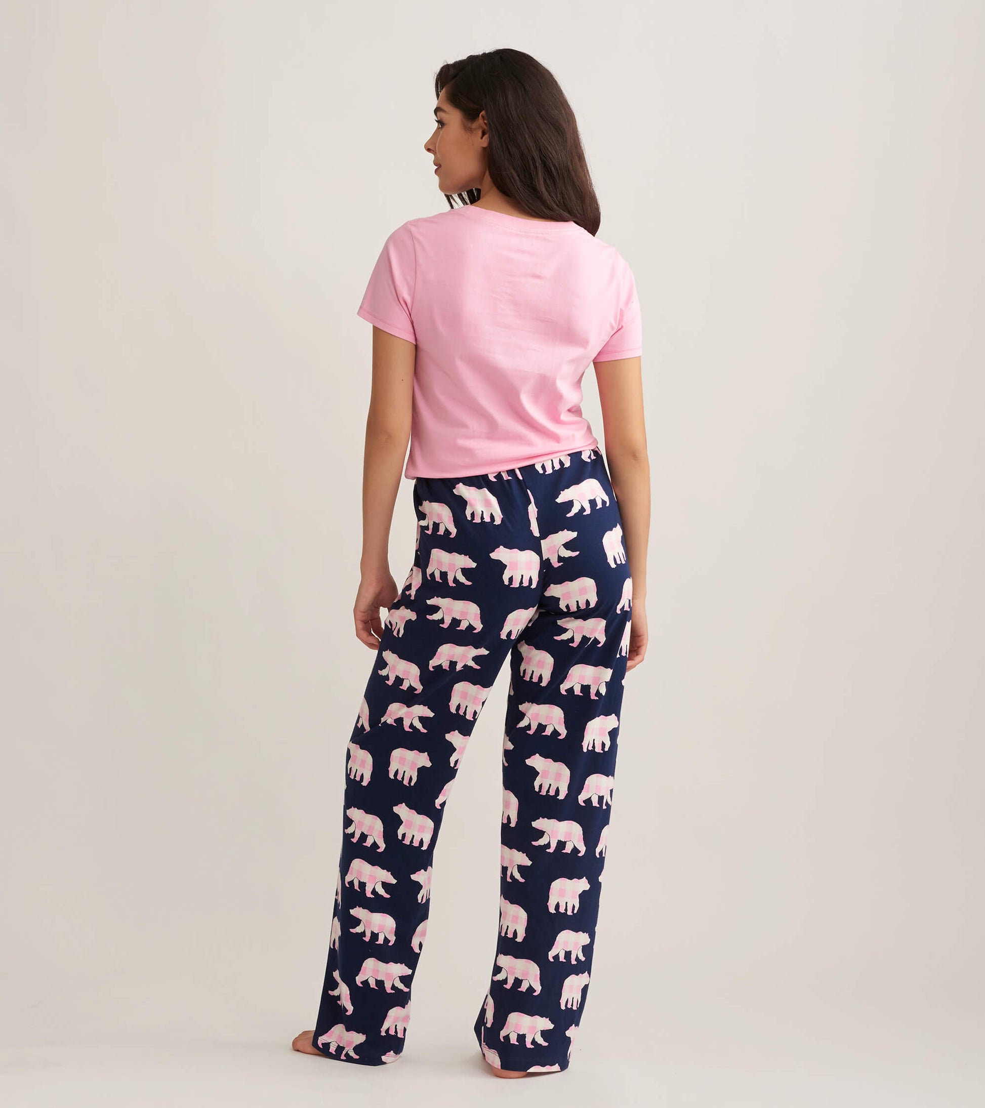 Navy cotton pajama pants with a playful pink bear pattern, shown from the back with a pink t-shirt.