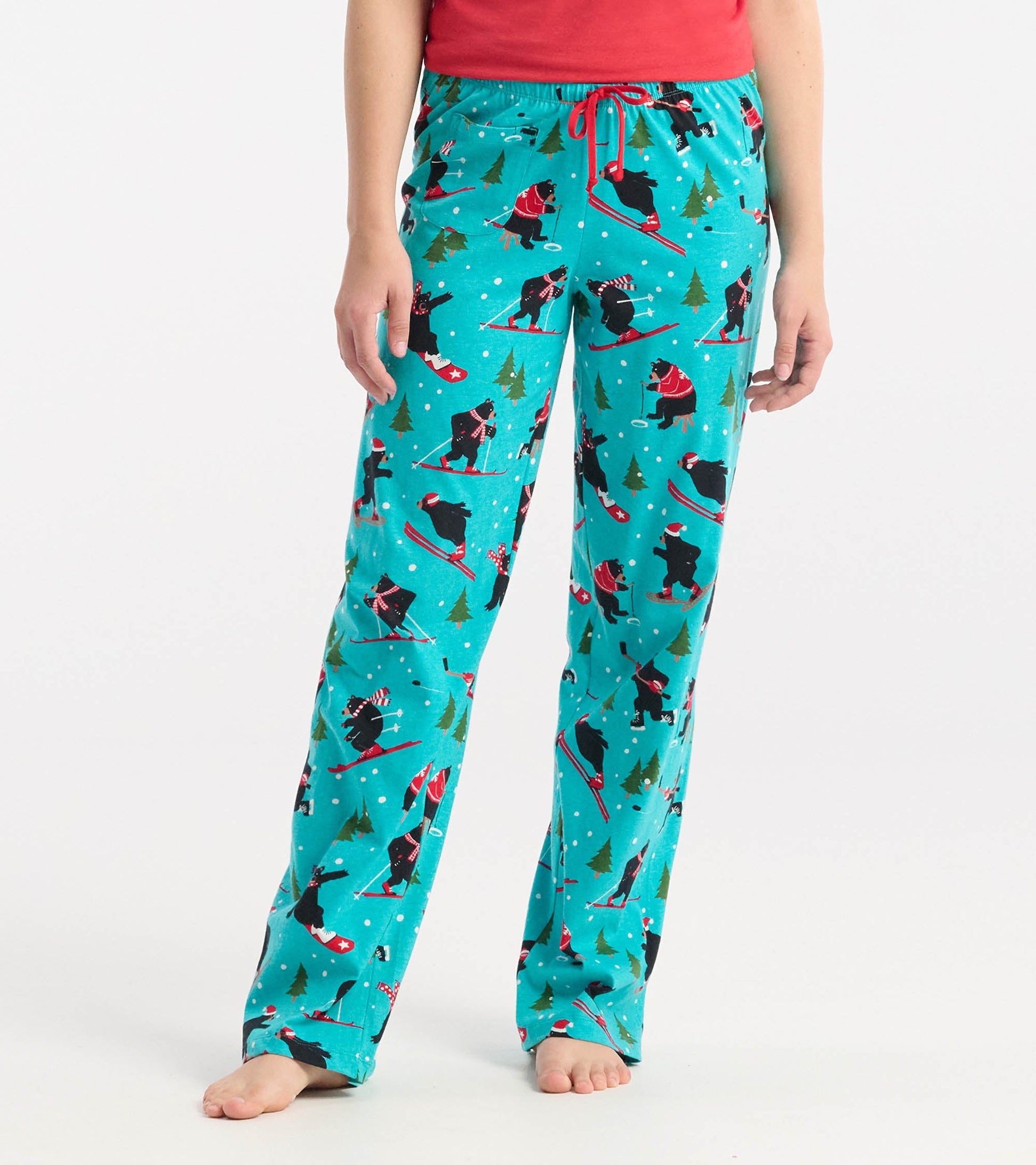 Turquoise cotton pajama pants featuring a playful skiing bear pattern, with an elastic waistband and drawstring.