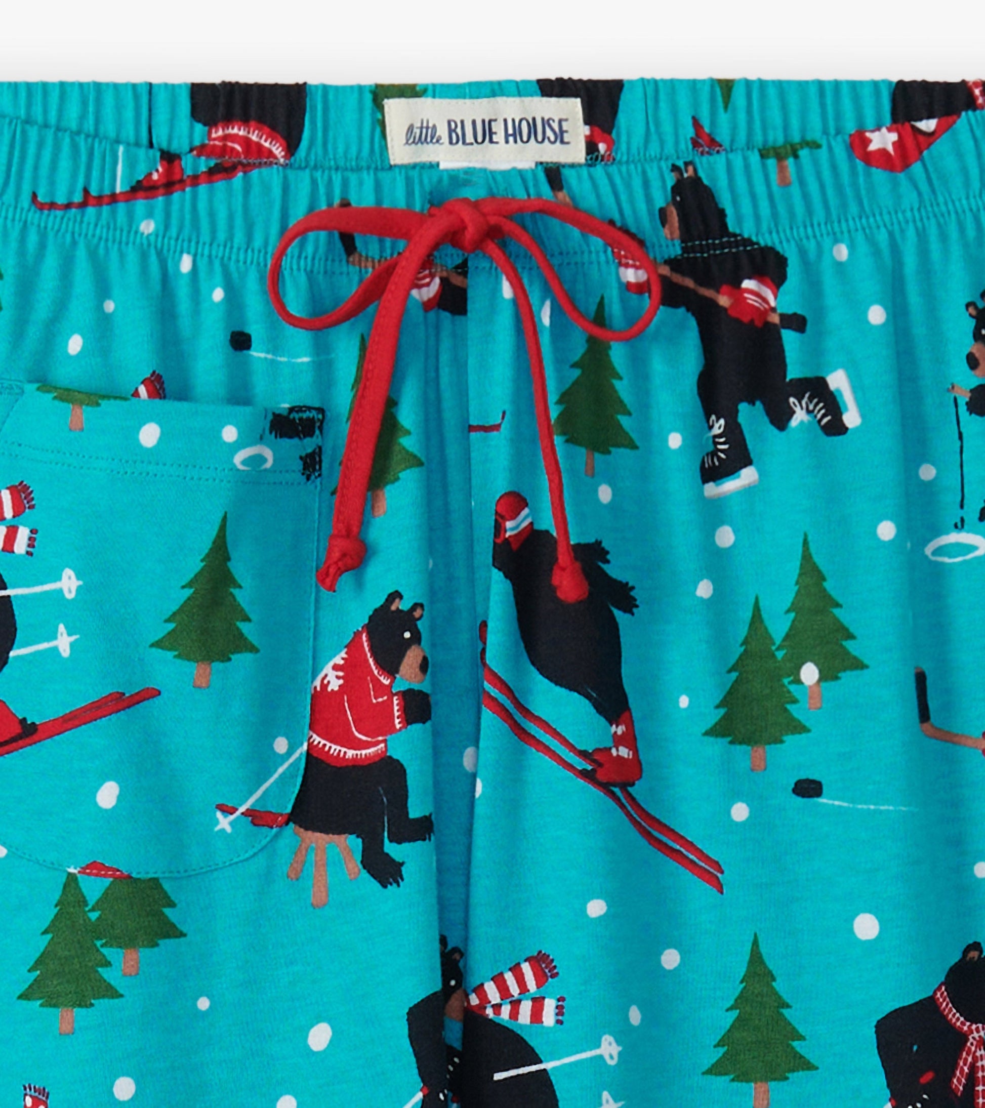 Turquoise cotton pajama pants featuring playful bear skiing patterns and a red drawstring waist.