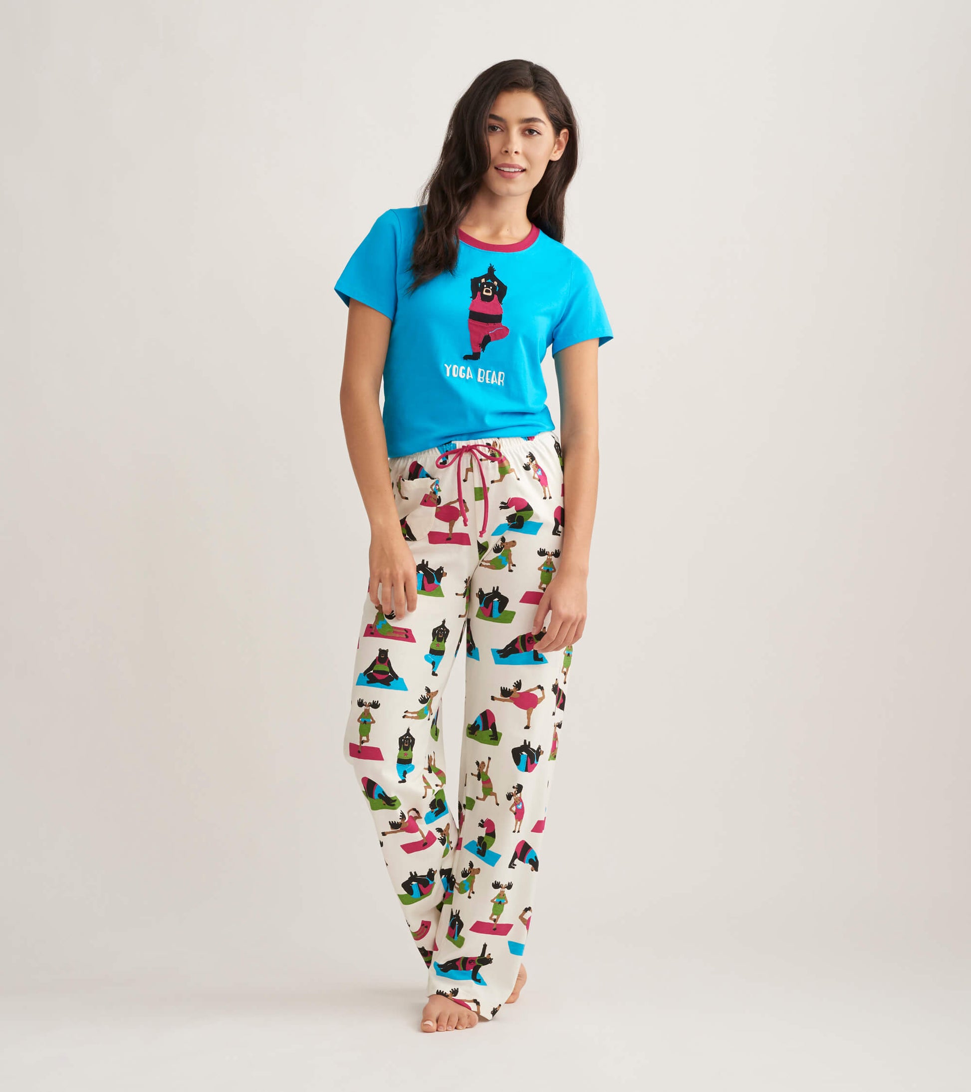 Women's cotton pajama pants featuring a colorful yoga bear print on a cream background, with a relaxed fit and drawstring wa…