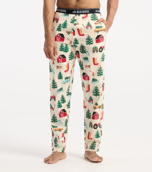 Cream cotton pajama pants featuring a festive Christmas tree farm pattern with barns, trees, and holiday elements.