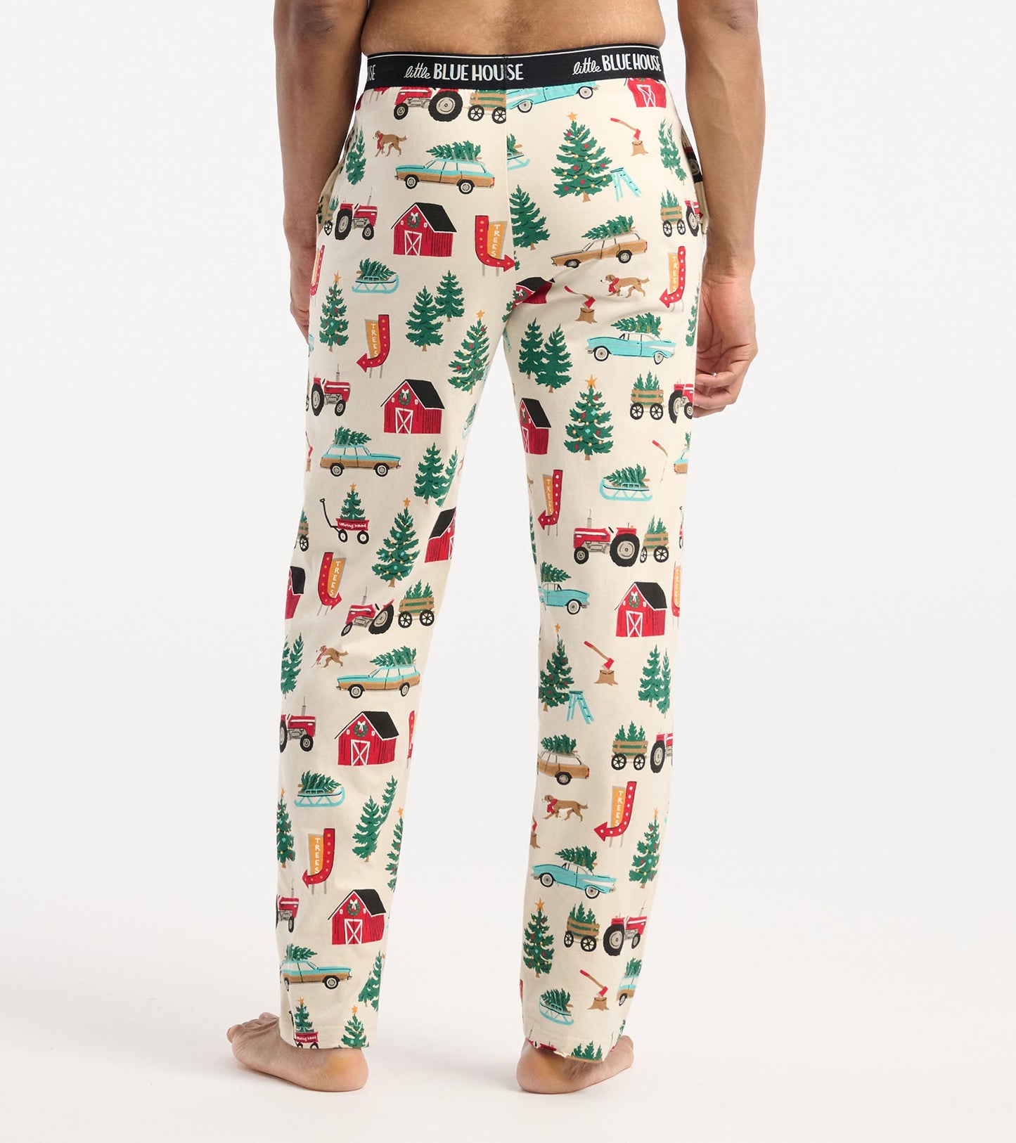 Cotton pajama pants featuring a festive Christmas tree farm pattern in cream, with red barns, green trees, and playful motif…