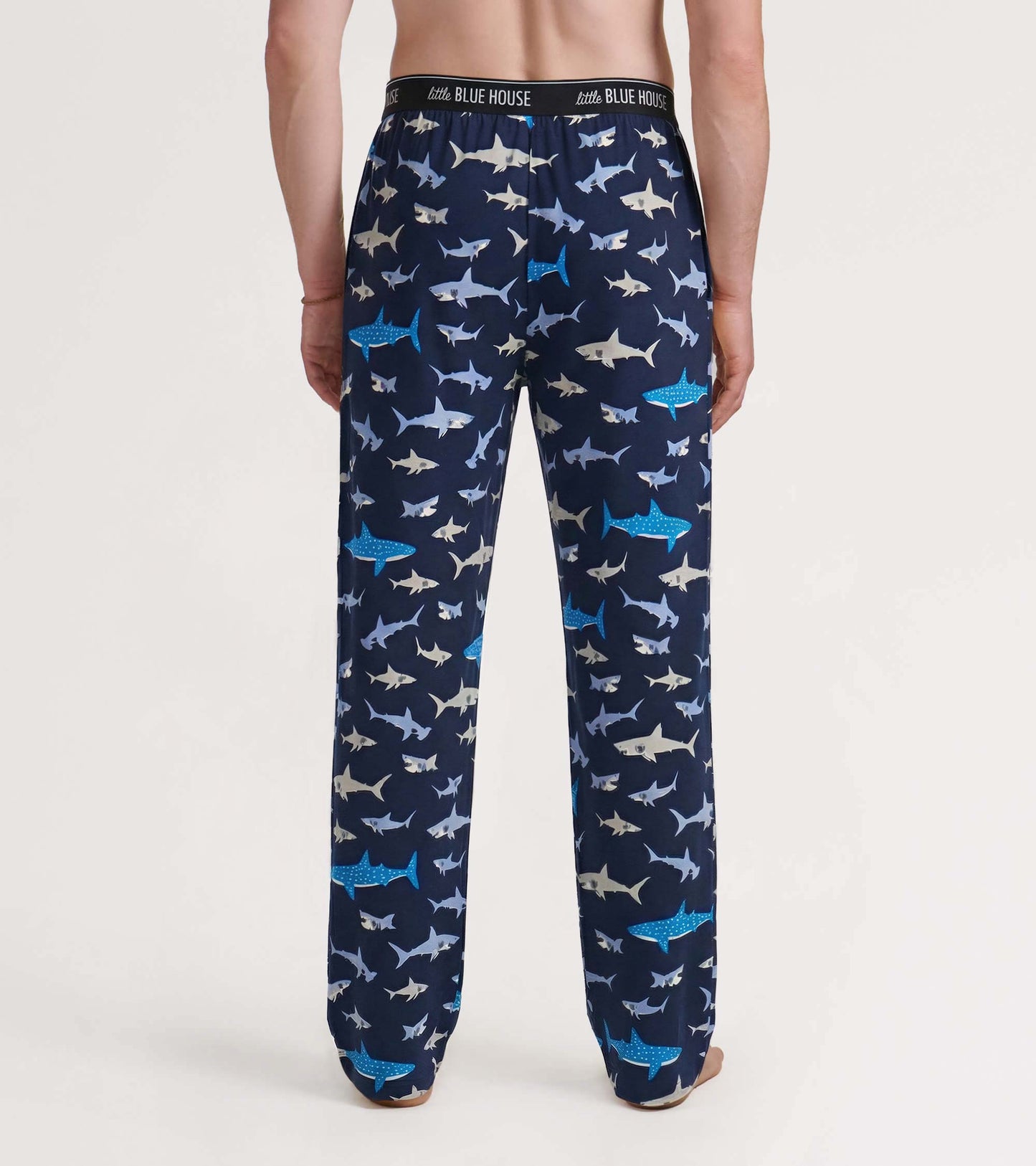 Back view of navy pajama pants with allover shark print and elastic waistband