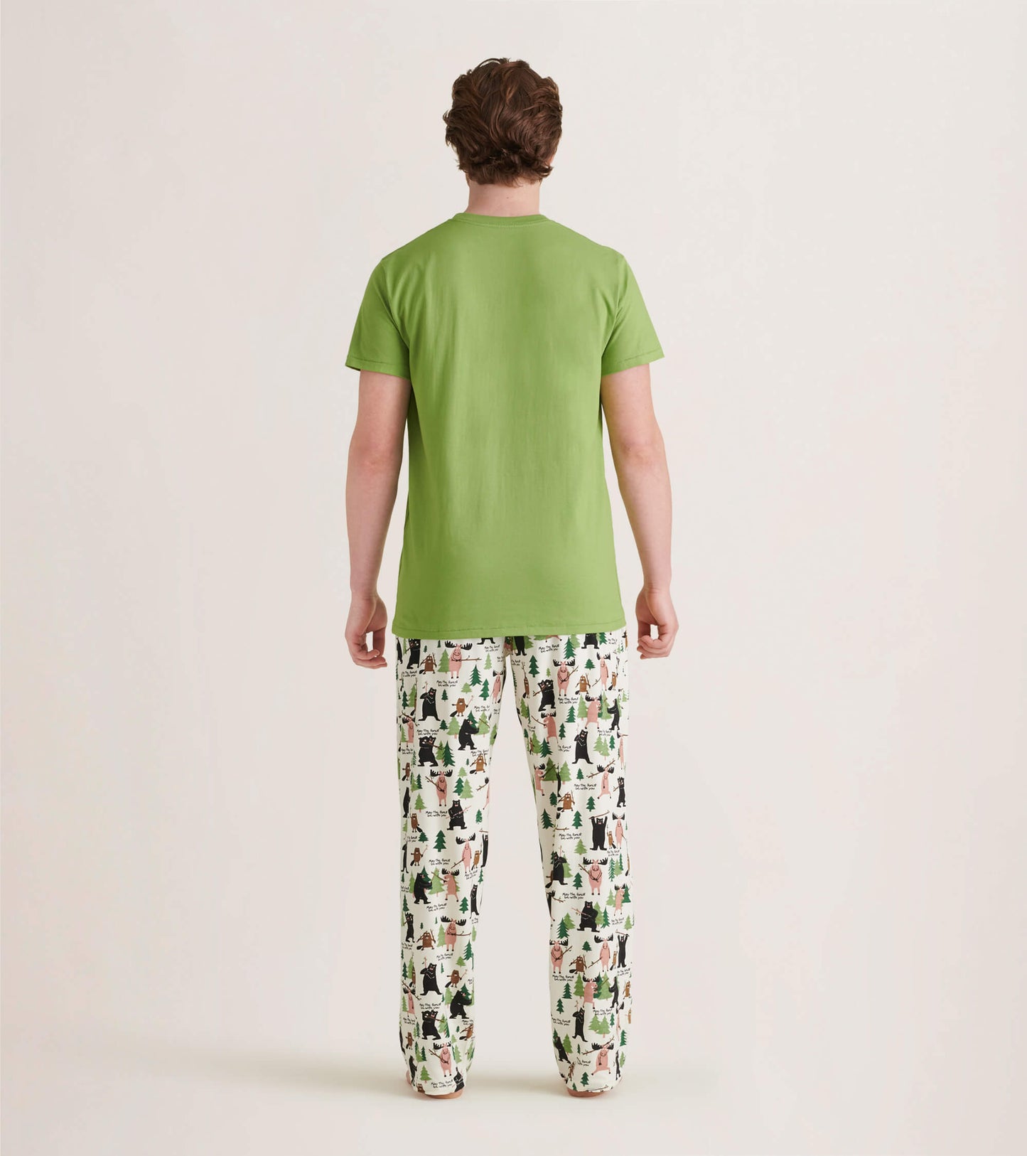 Men's pajama pants in white with a forest animal print, made of stretch cotton, shown from the back.