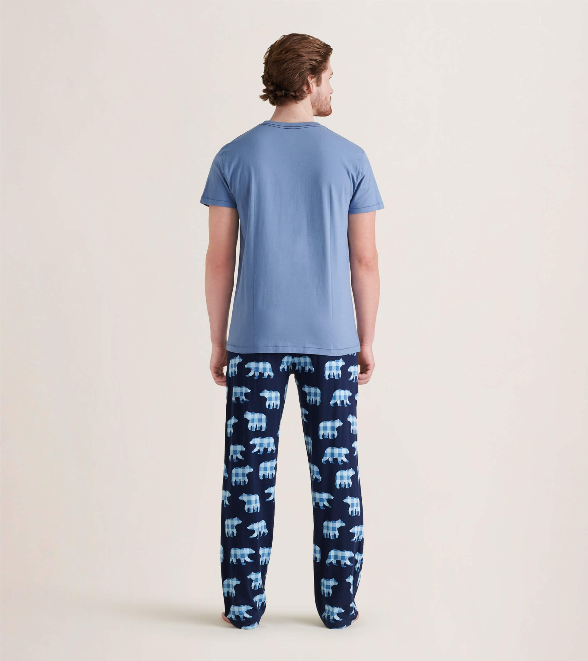 Men's pajama pants in navy with light blue bear pattern, made of stretch cotton, shown from the back.