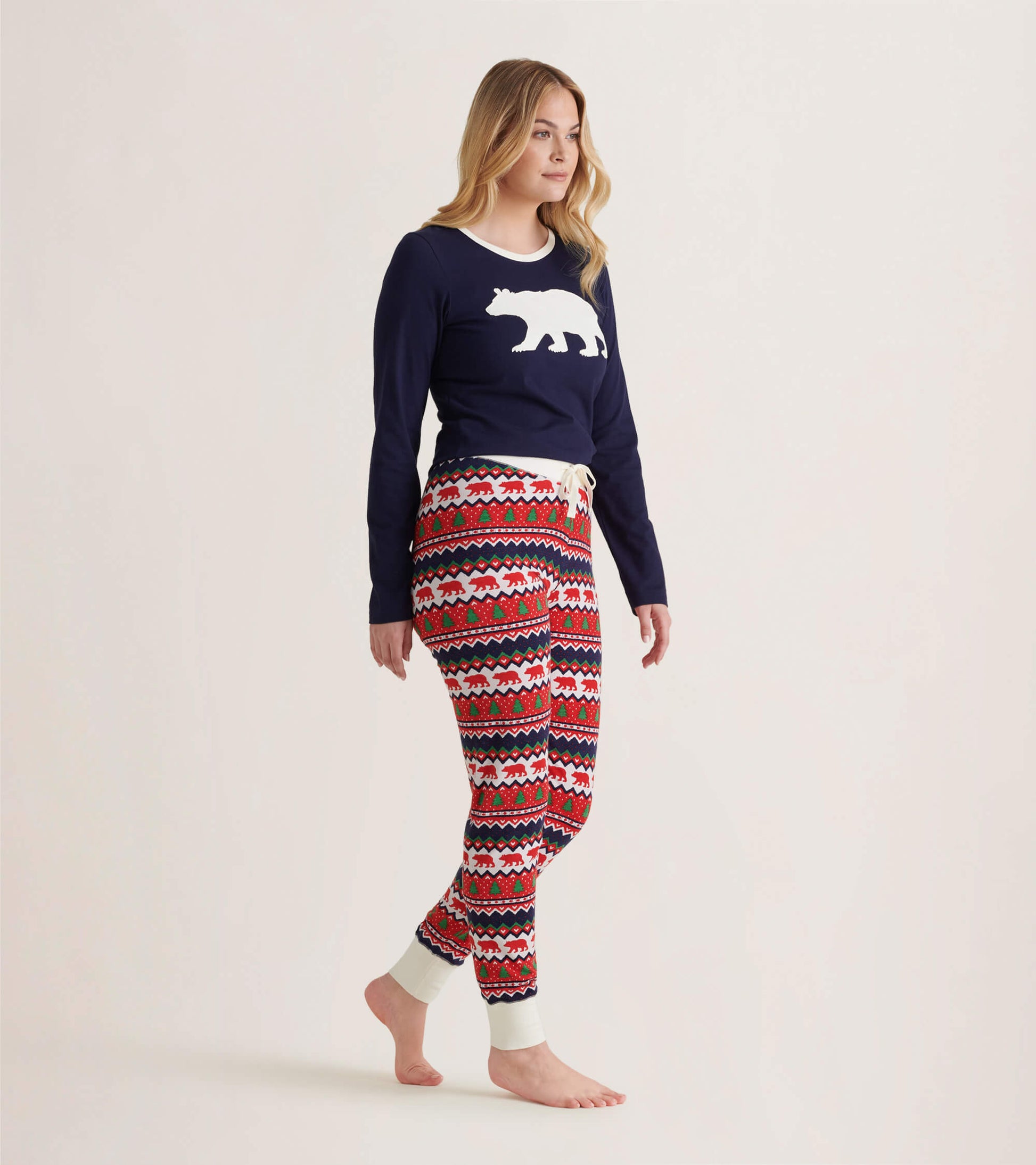 Red and white Fair Isle patterned leggings with bear motifs, featuring a fitted shape and cuffed ankles.