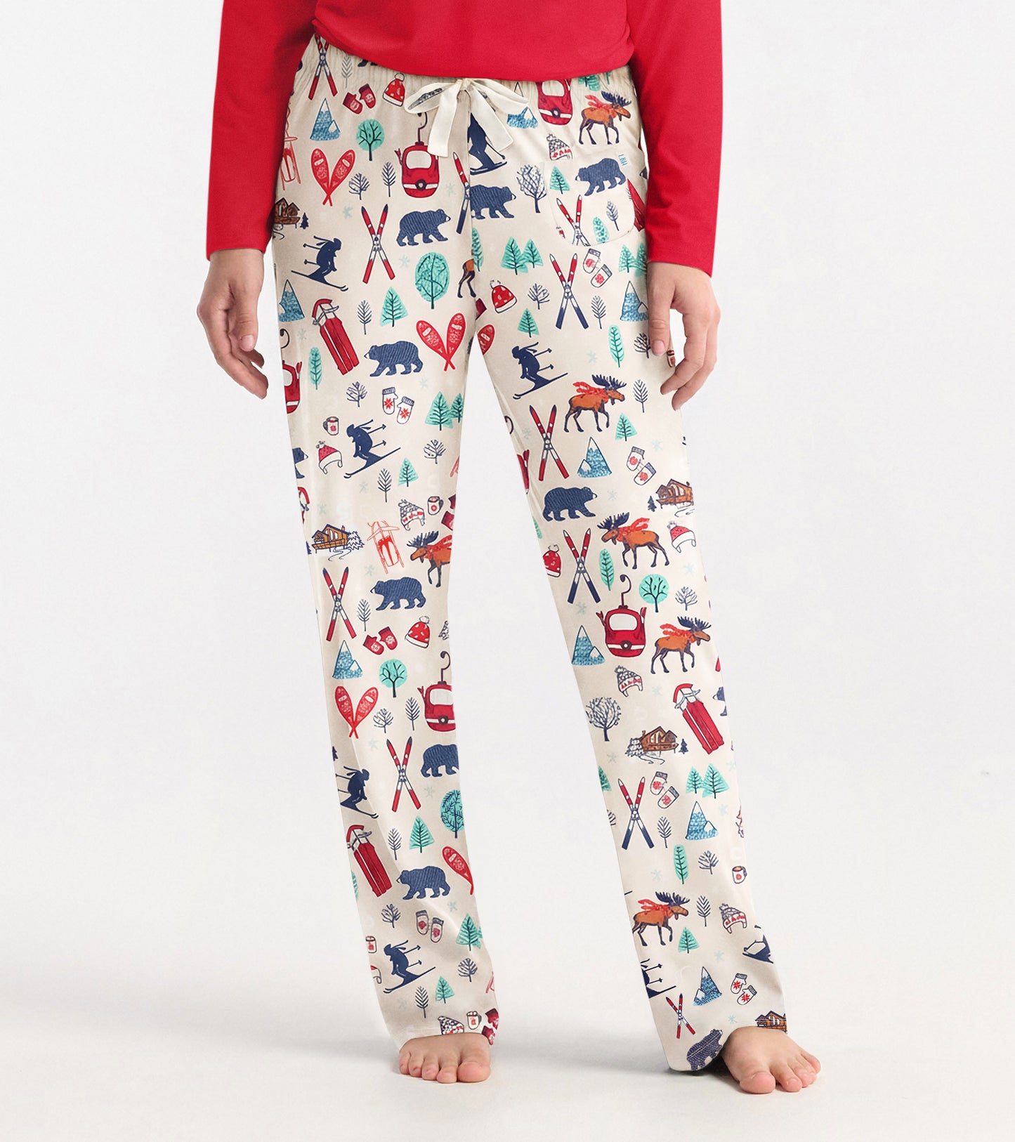 Cream pajama pants featuring a colorful vintage ski and wildlife print, with an elastic waistband and drawstring.