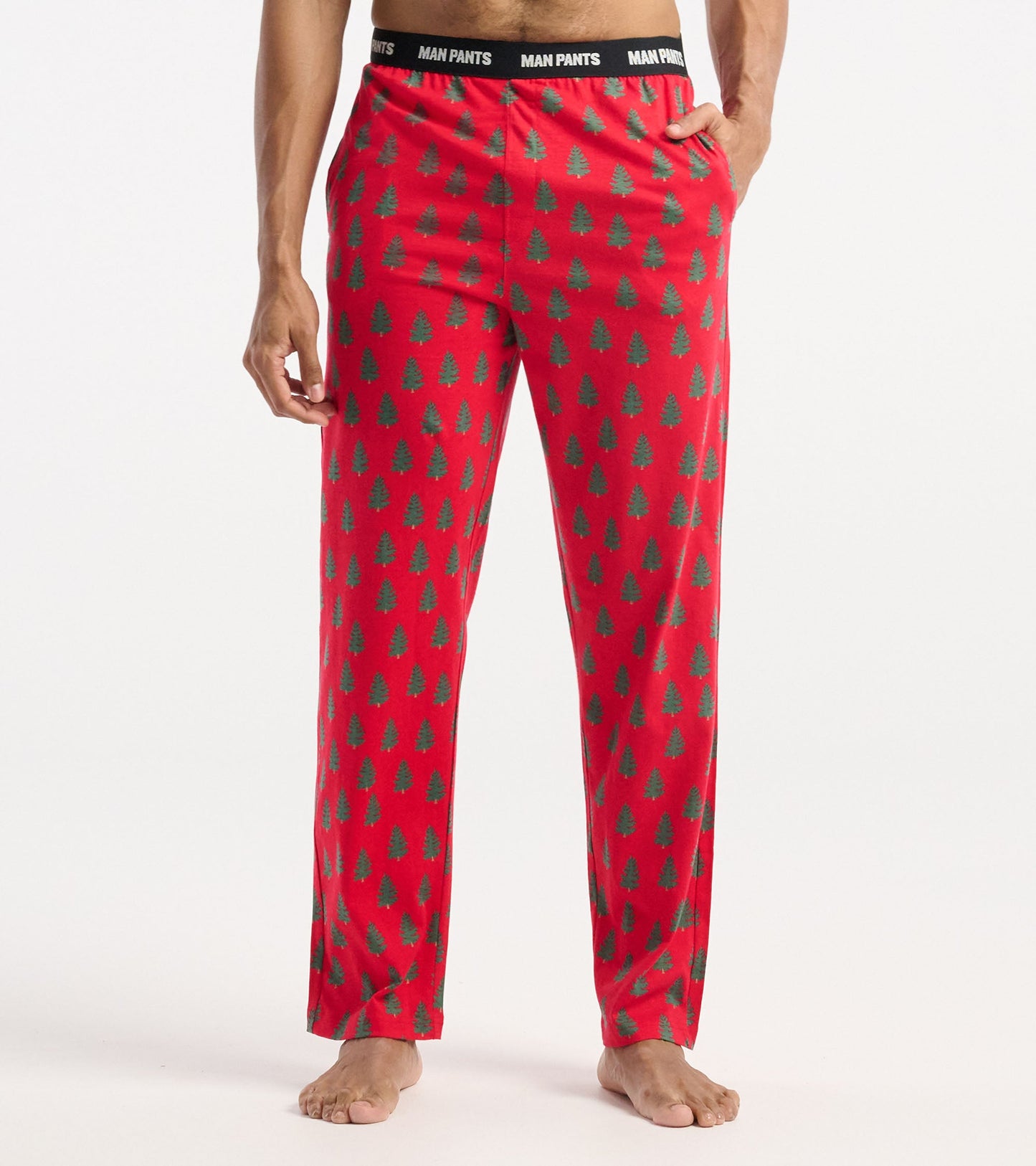 Red pajama pants featuring a green tree pattern, with an elastic waistband and side pockets.