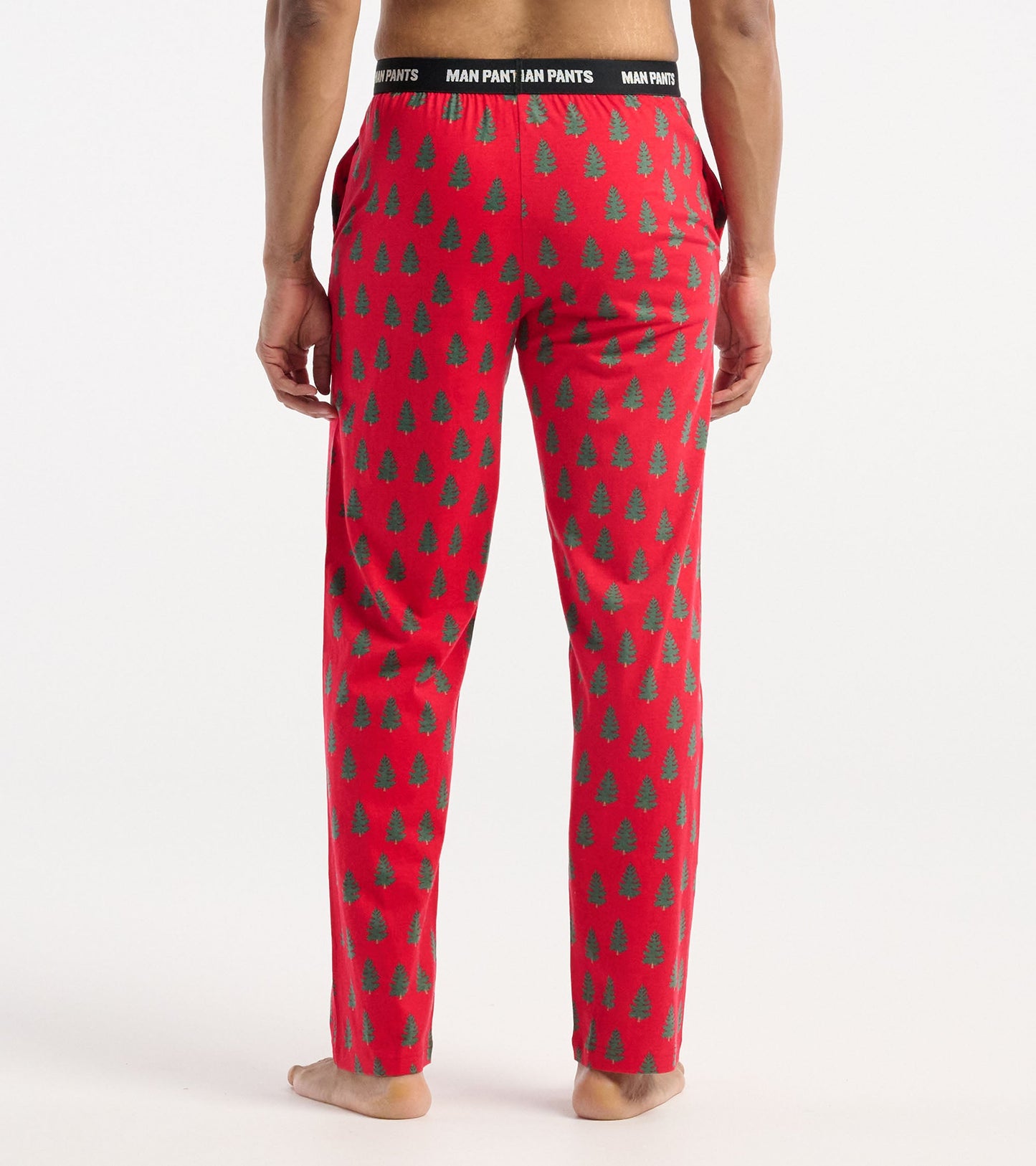 Red pants featuring a tree pattern, with an elastic waistband, shown from the back. Suitable for casual wear.