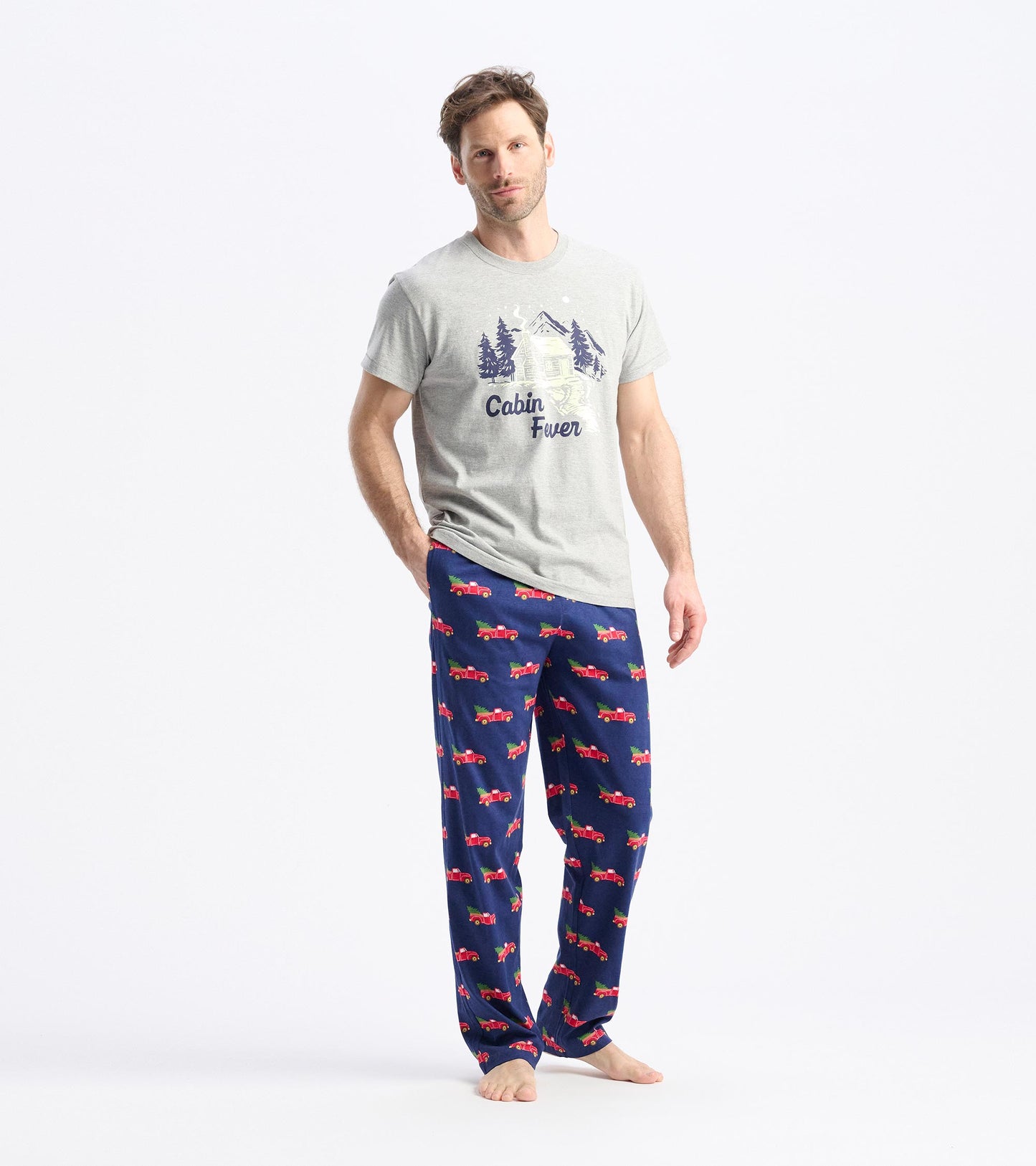 Gray t-shirt with "Cabin Fever" print paired with navy pajama pants featuring red trucks.