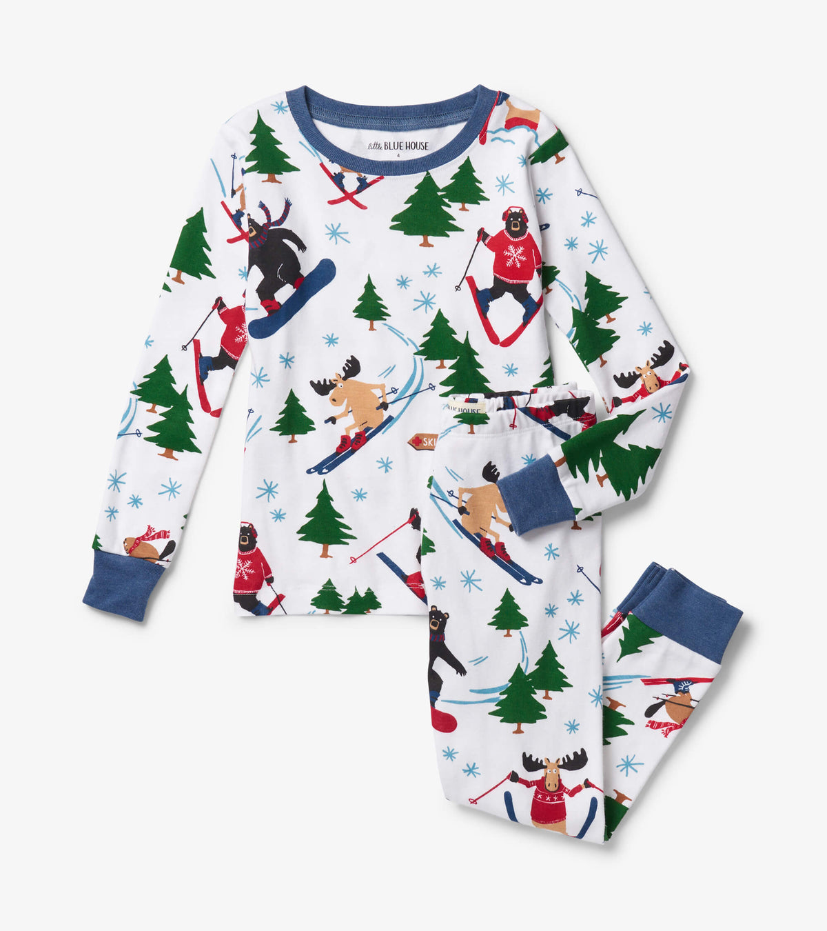 White kids pajama set with blue cuffs and skiing bear, moose, tree, and snowflake print